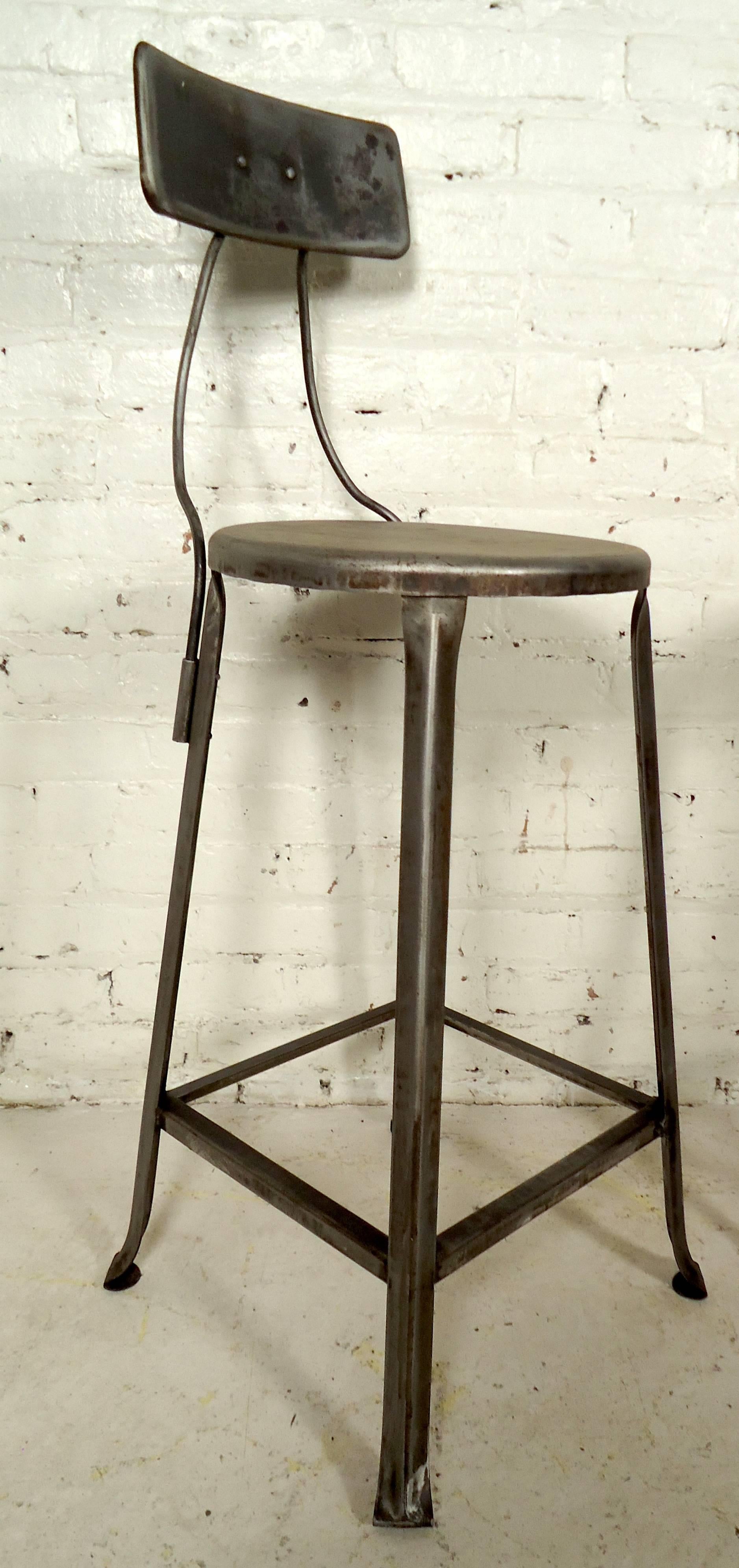 Two vintage industrial Toledo style stools featuring sturdy base and beautiful bent iron backrest.

Please confirm item location NY or NJ with dealer.