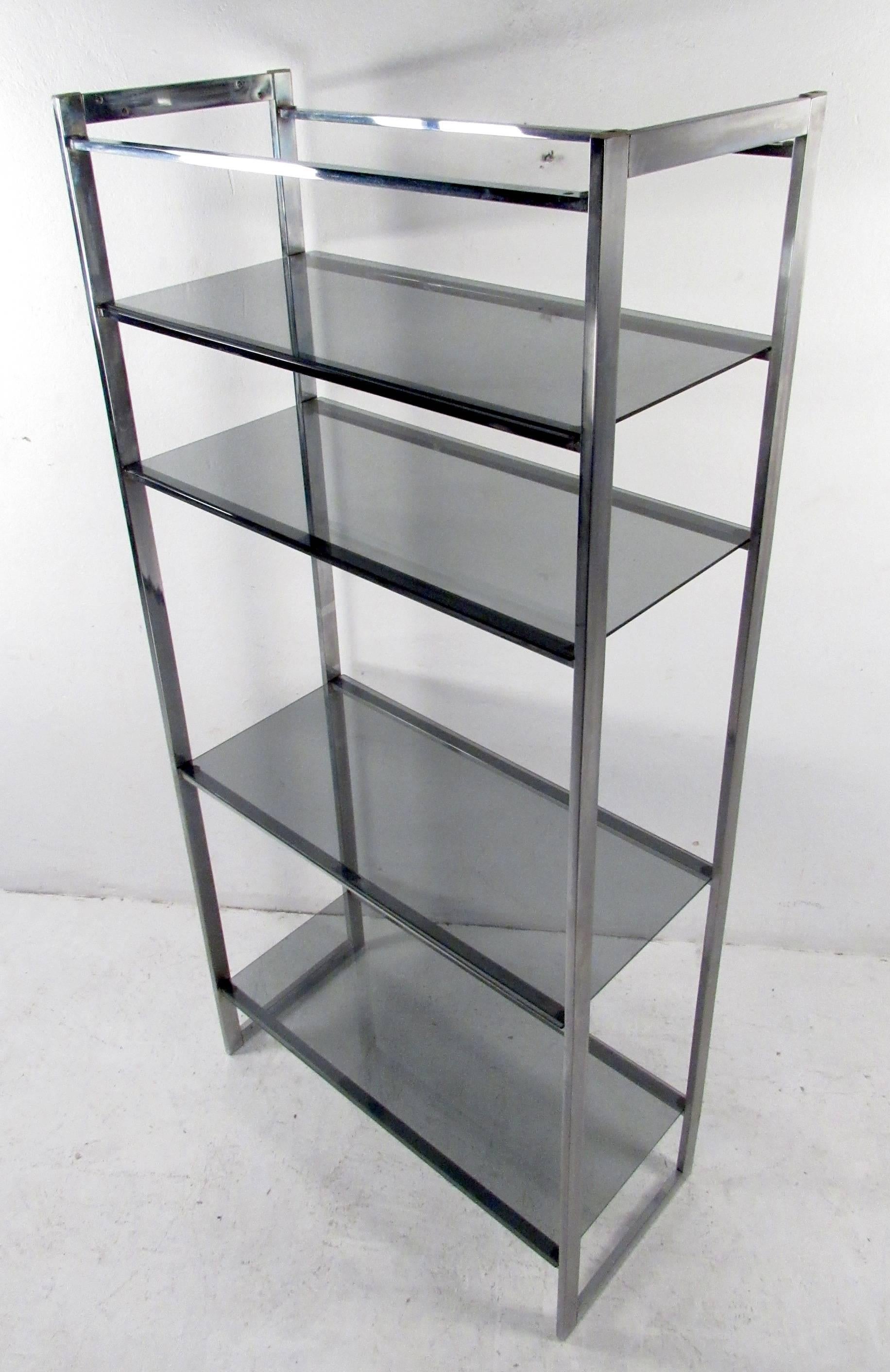 Vintage modern Milo Baughman bookshelf featuring chrome body with smoked glass shelving. Ideal mid-century etagere for shop display or home storage. 

Please confirm item location NY or NJ with dealer.