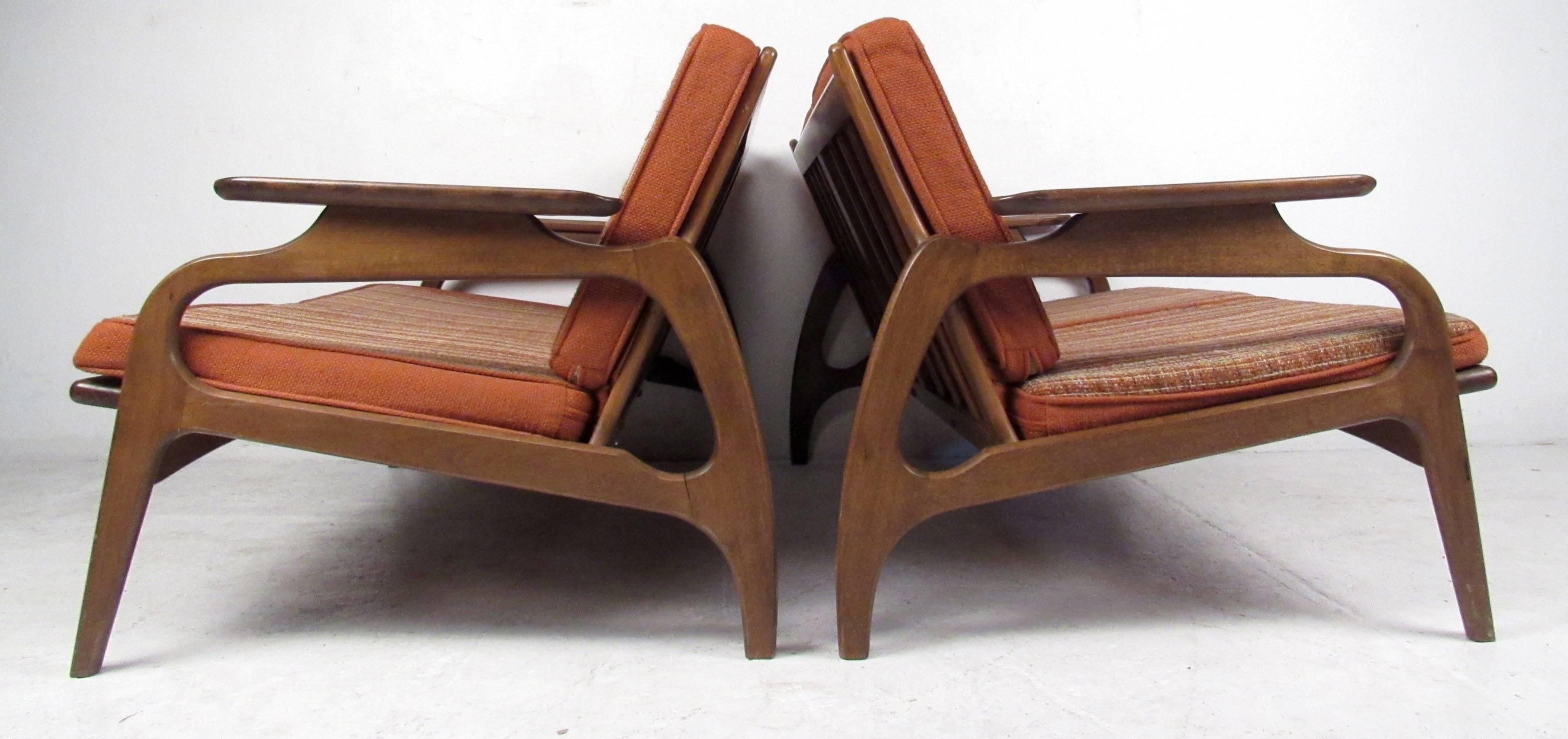 Pair of vintage-modern settees featuring beautifully sculpted walnut arms and legs with removable upholstered cushions.

Please confirm item location NY or NJ with dealer.