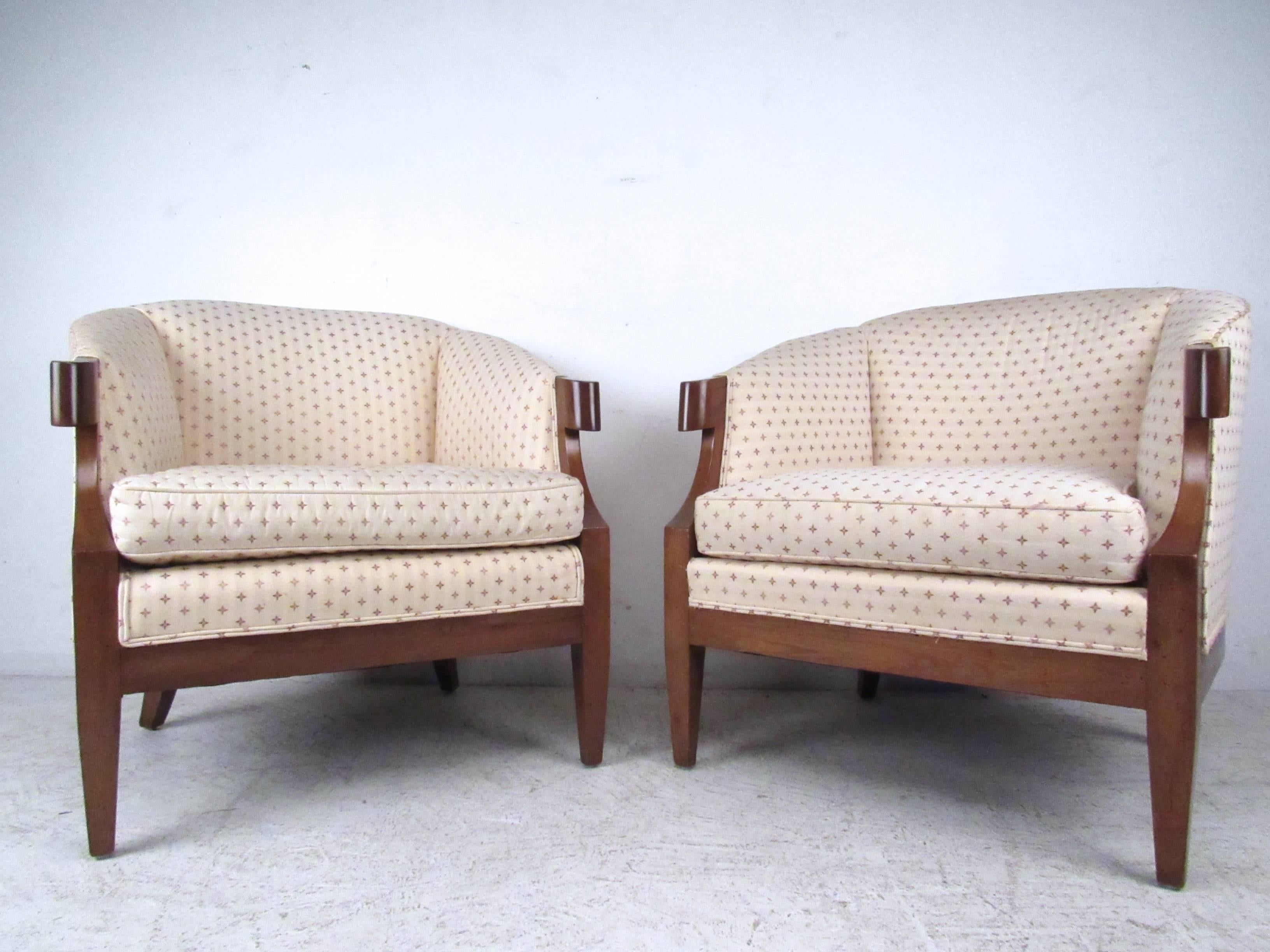 This unique and comfortable pair of matching arm chairs features unique upholstery, tapered legs, and unique stubbed armrests. Scroll wood handles add to the charm of the piece. Please confirm item location (NY or NJ).