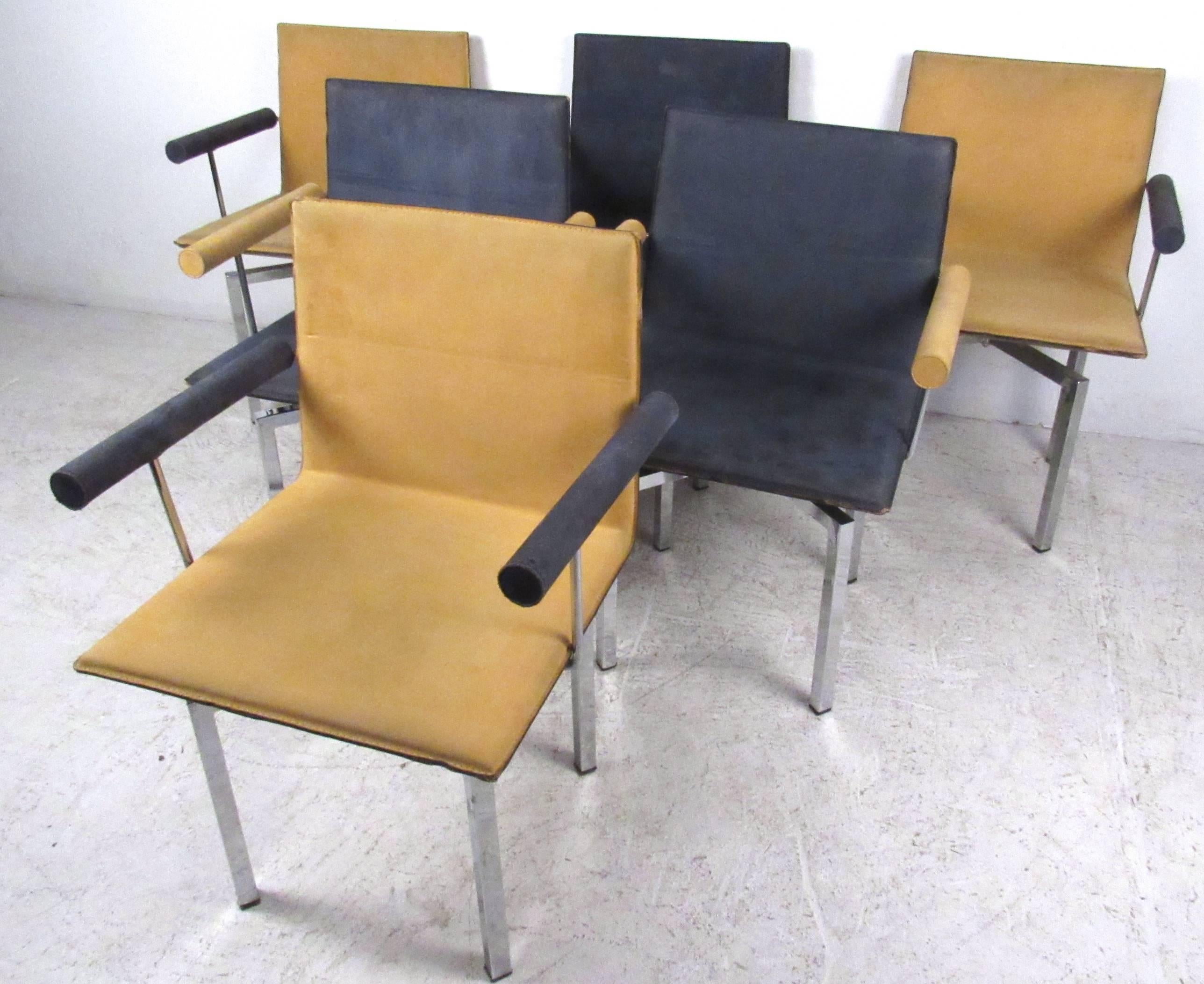 This Mid-Century style set of six two-tone dining chairs makes a funky retro addition to any dining room. Swivel seats, padded armrests, leather upholstery, and unique chrome base add to the style of these comfortable chairs. Please confirm item