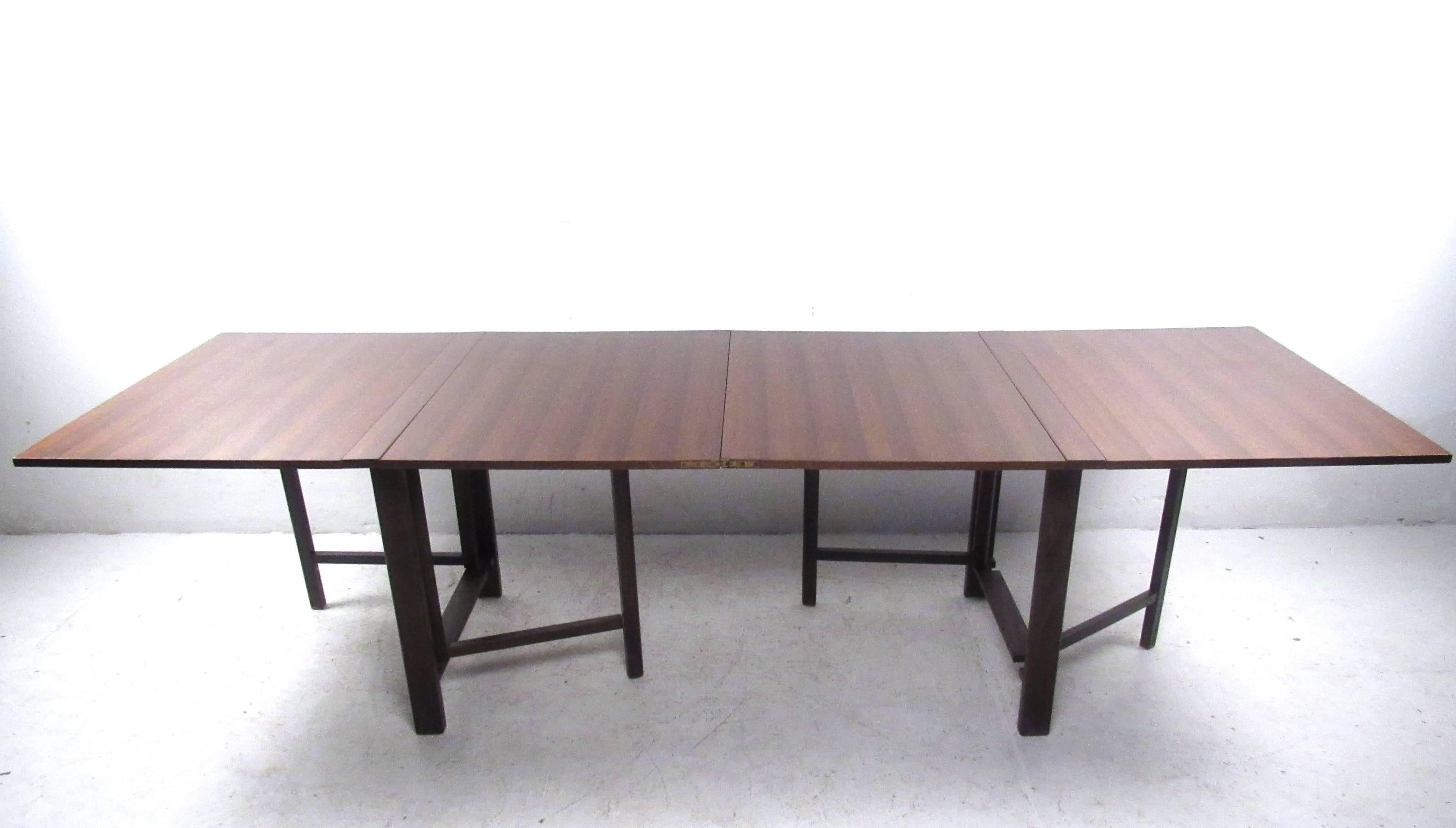 This unique vintage conference table makes a stylish and versatile addition to any interior. Expanding from 9.5 inches wide to 110 inches wide makes this perfect for large seating arrangements, while allowing it to be easily stored in its condensed