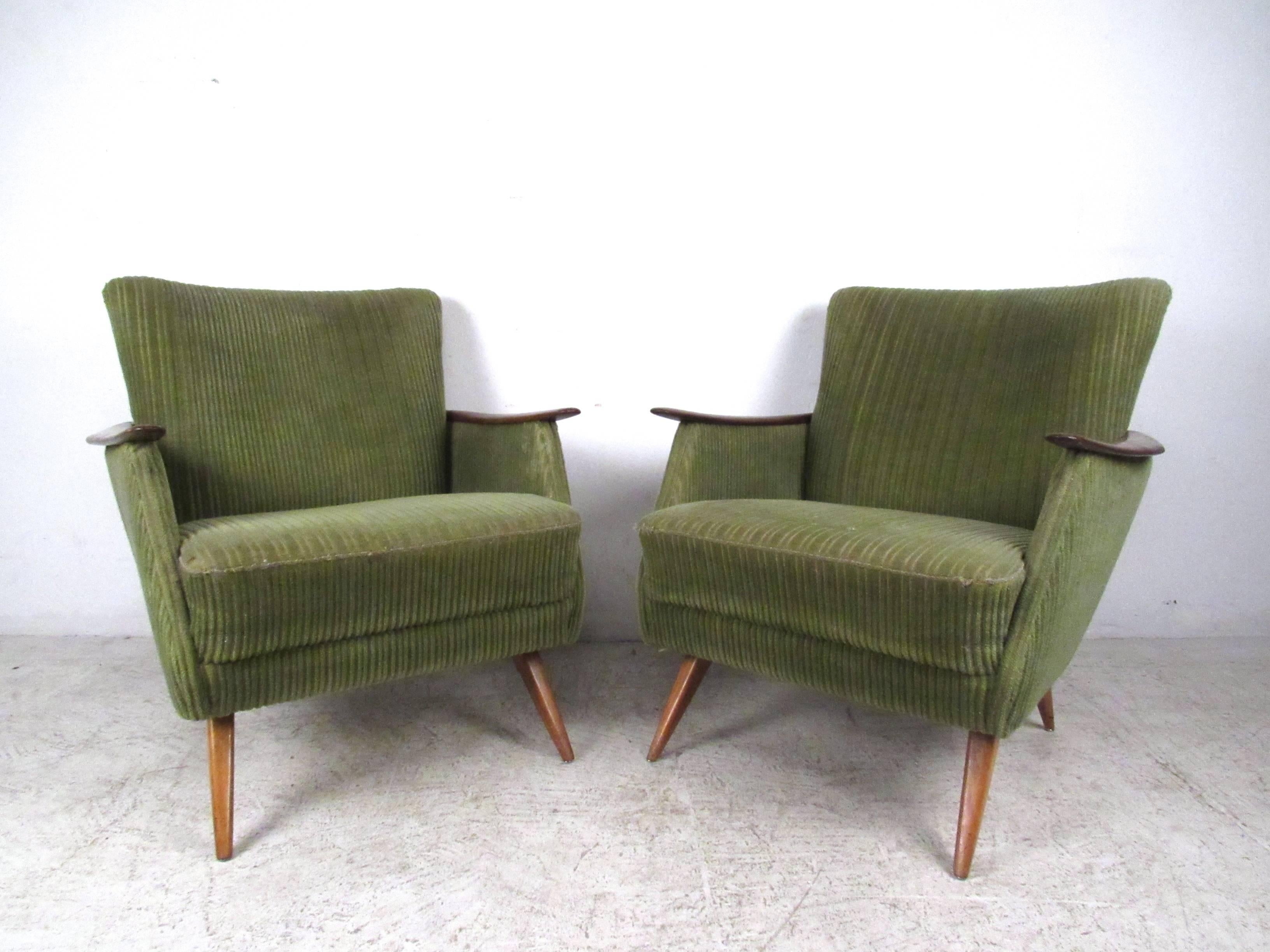 This stunning pair of vintage Danish armchairs features unique tapered legs, sculpted wooden arms, and wraparound wood trim. The vintage style and modern comfort of the pair make these a unique addition to any interior. Matching sofa available,