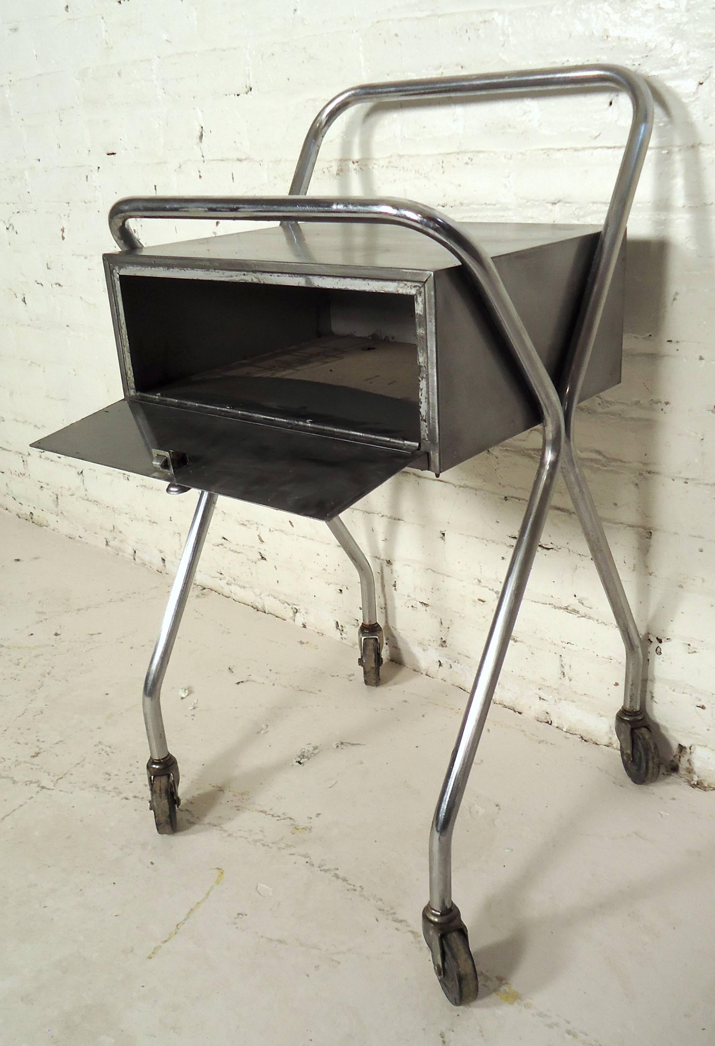 Industrial metal rolling table featuring one drawer and a bent chrome frame on wheels.

Please confirm item location NY or NJ with dealer.