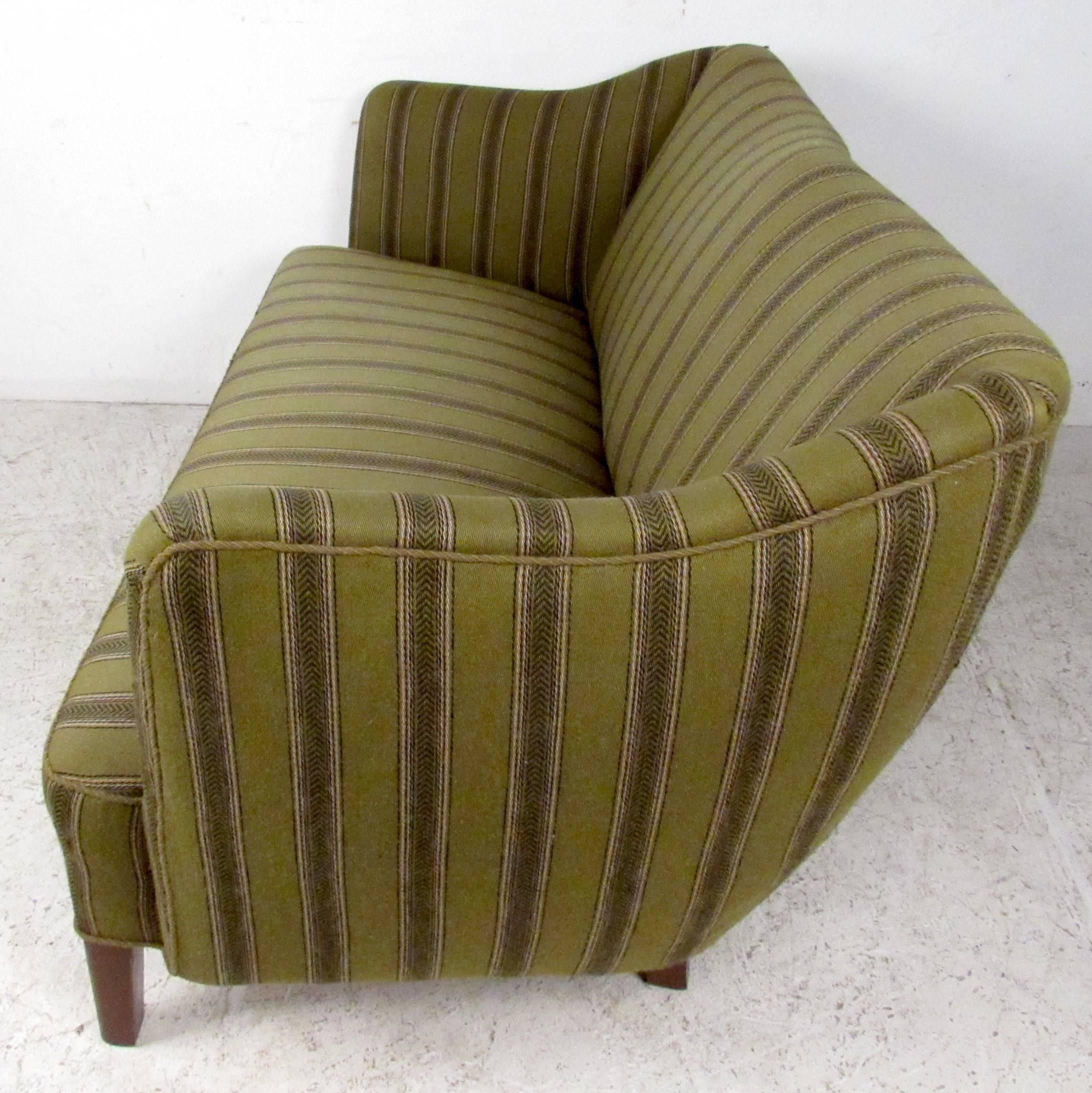 Scandinavian modern sofa features sculpted frame with vintage striped upholstery and hardwood legs. Comfortable loveseat makes an impressive mid-century addition to any interior. Please confirm item location (NY or NJ). 