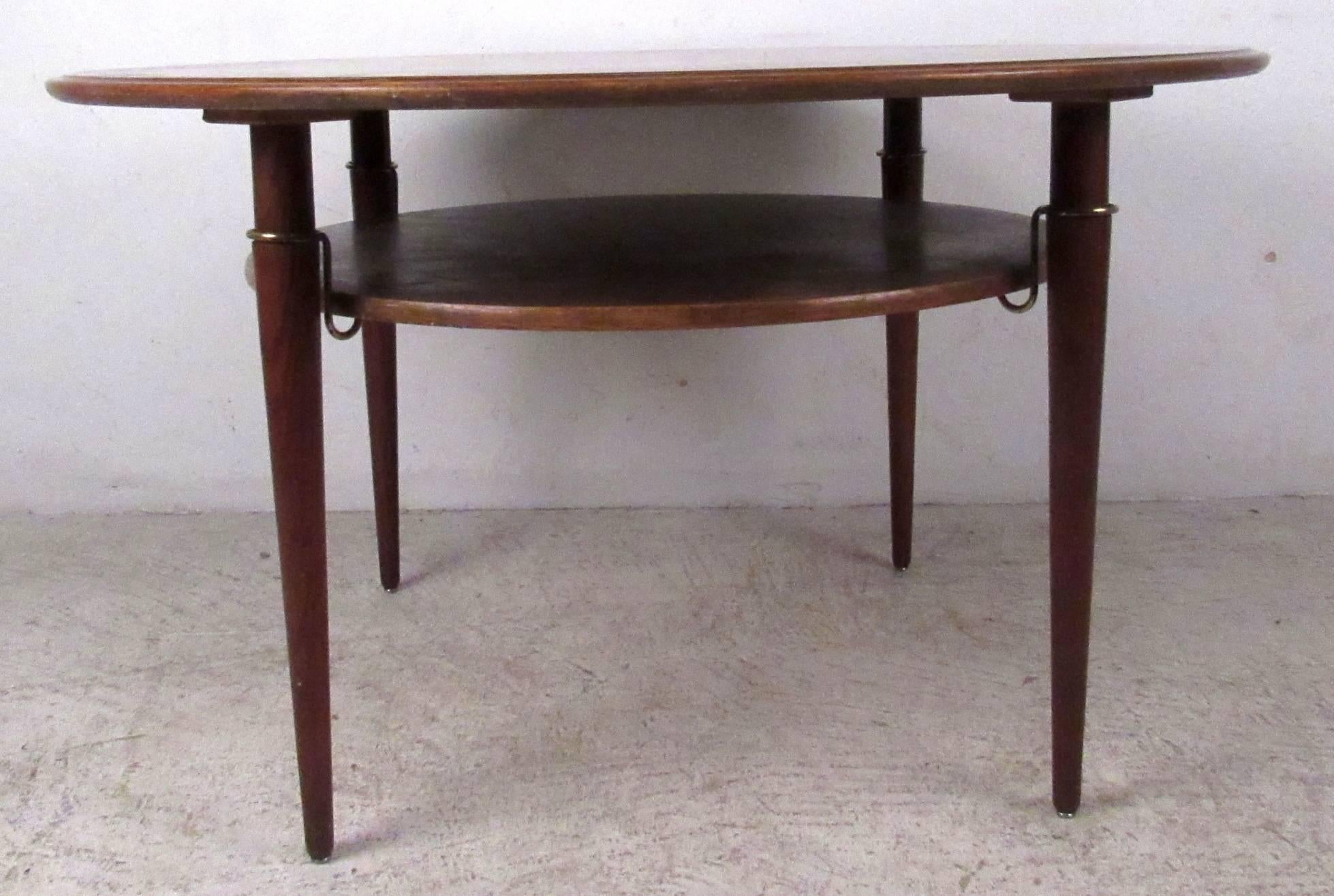 Vintage modern cocktail table featuring beautifully sculpted base with lower shelf and round top. (Matching sofa and chairs sold separately, see pictures).

Please confirm item location NY or NJ with dealer.