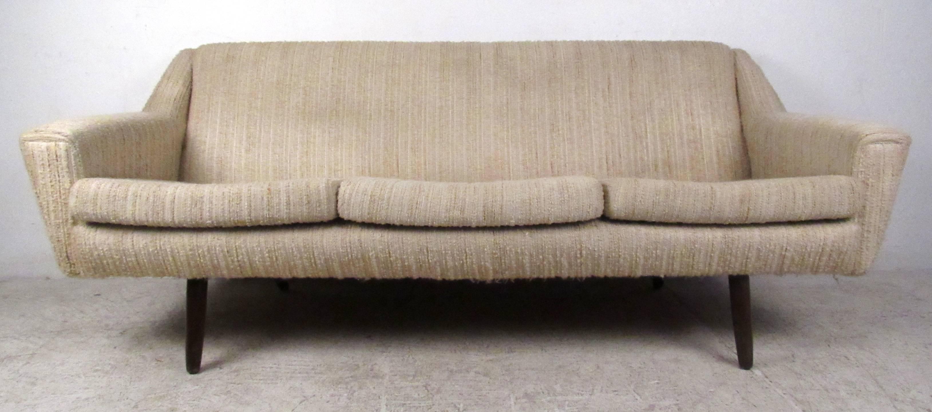 Vintage modern sofa featuring upholstered removable cushions and tapered legs. Stylish lightweight sofa with Danish modern design is perfect for home or business seating areas. 

Please confirm item location NY or NJ with dealer.