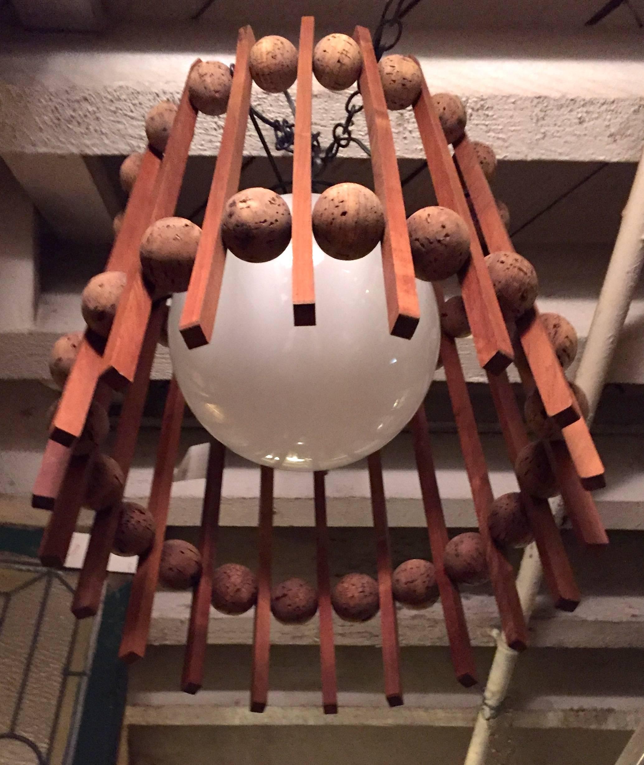 Vintage modern chandelier with teak and cork slatted shade. Large white glass globe for a subdued light.

(Please confirm item location - NY or NJ - with dealer).
 
