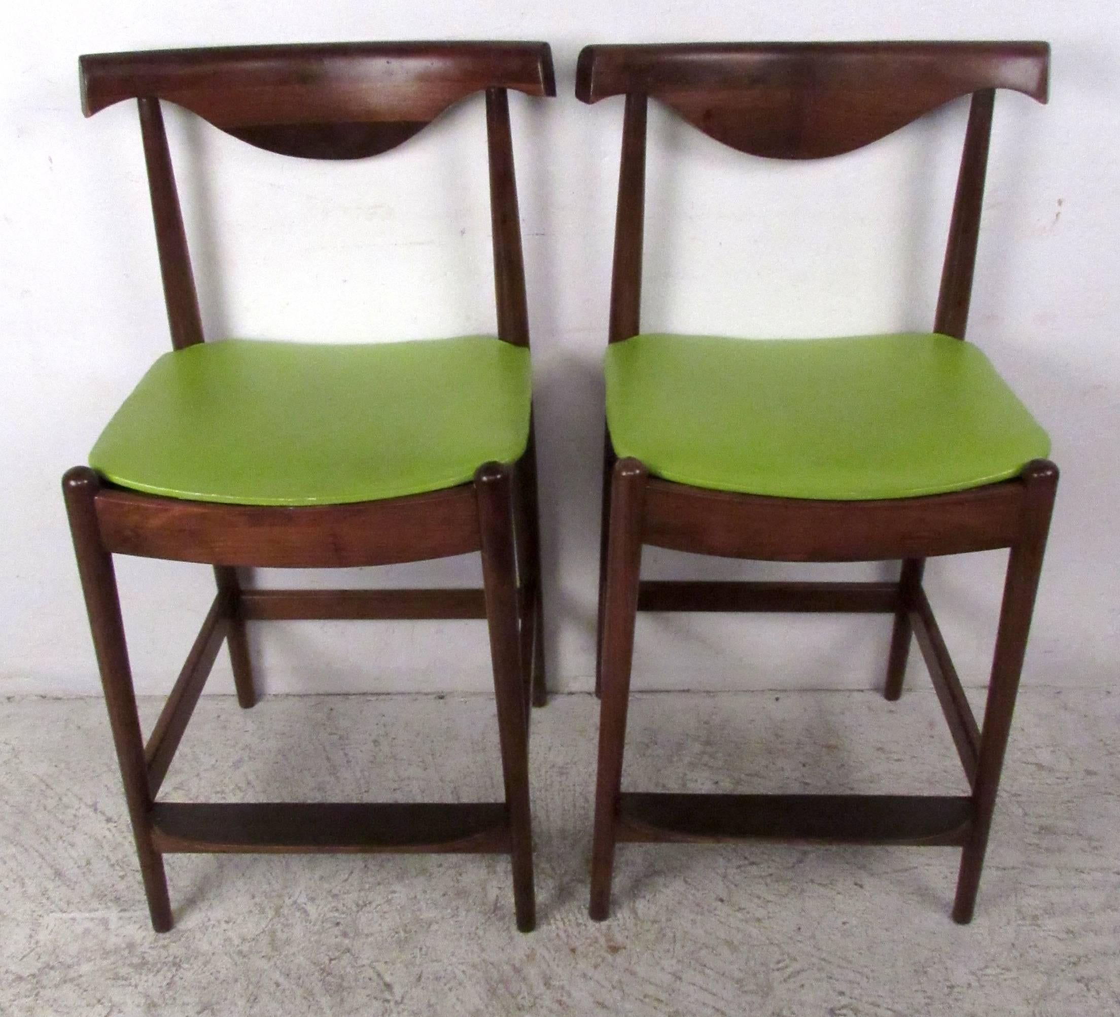 Two vintage-modern counter stools feature sculpted wood frames and vinyl upholstered seats. Perfect seating pair for kitchen or shop use. 

Please confirm item location NY or NJ with dealer.