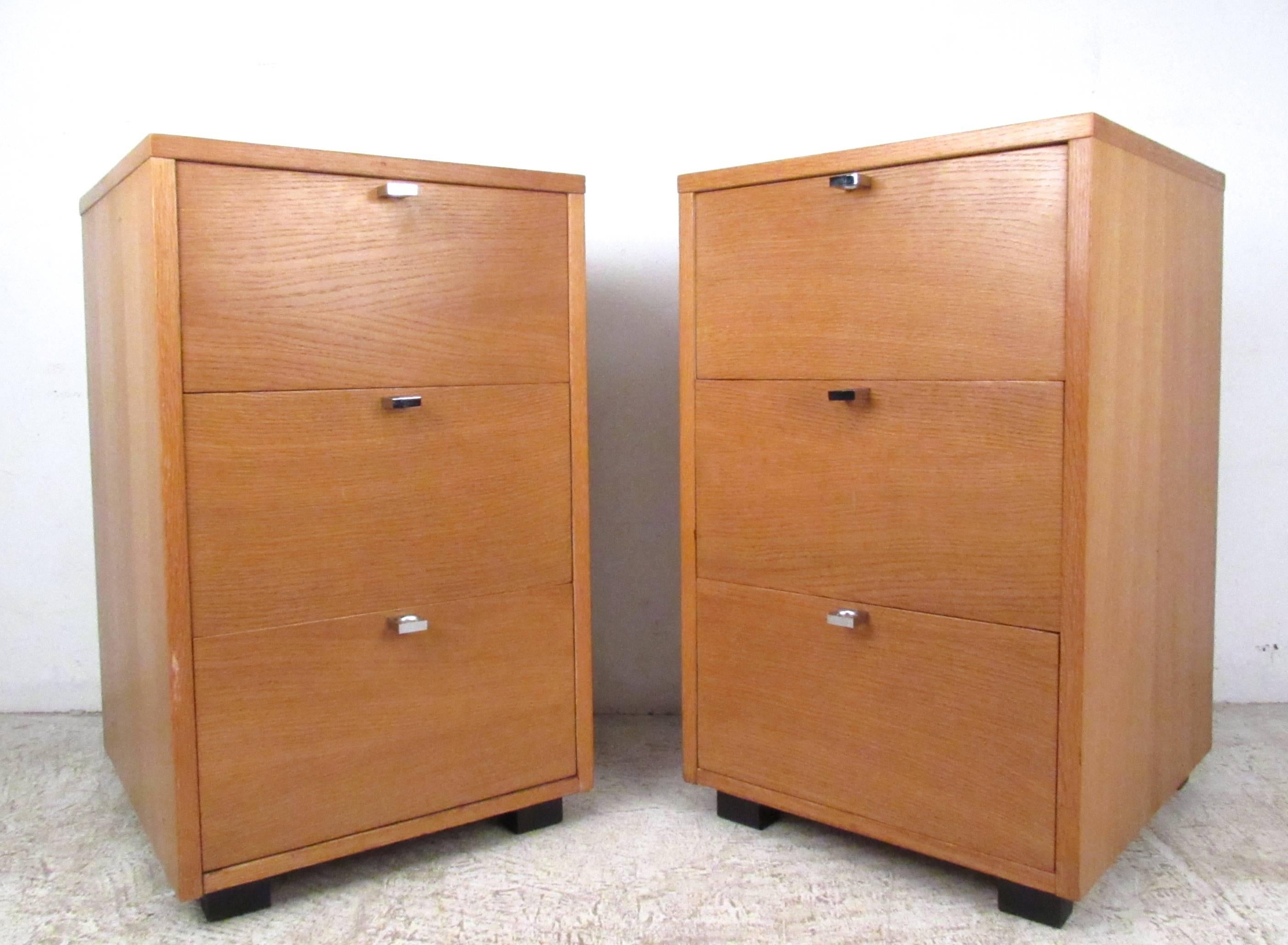 This uniquely sized pair of tall vintage nightstands features spacious three-drawer design, complete with original manufacturers mark. Circular chrome drawer pulls and low profile legs add to the Mid-Century style of the pair. Please confirm item