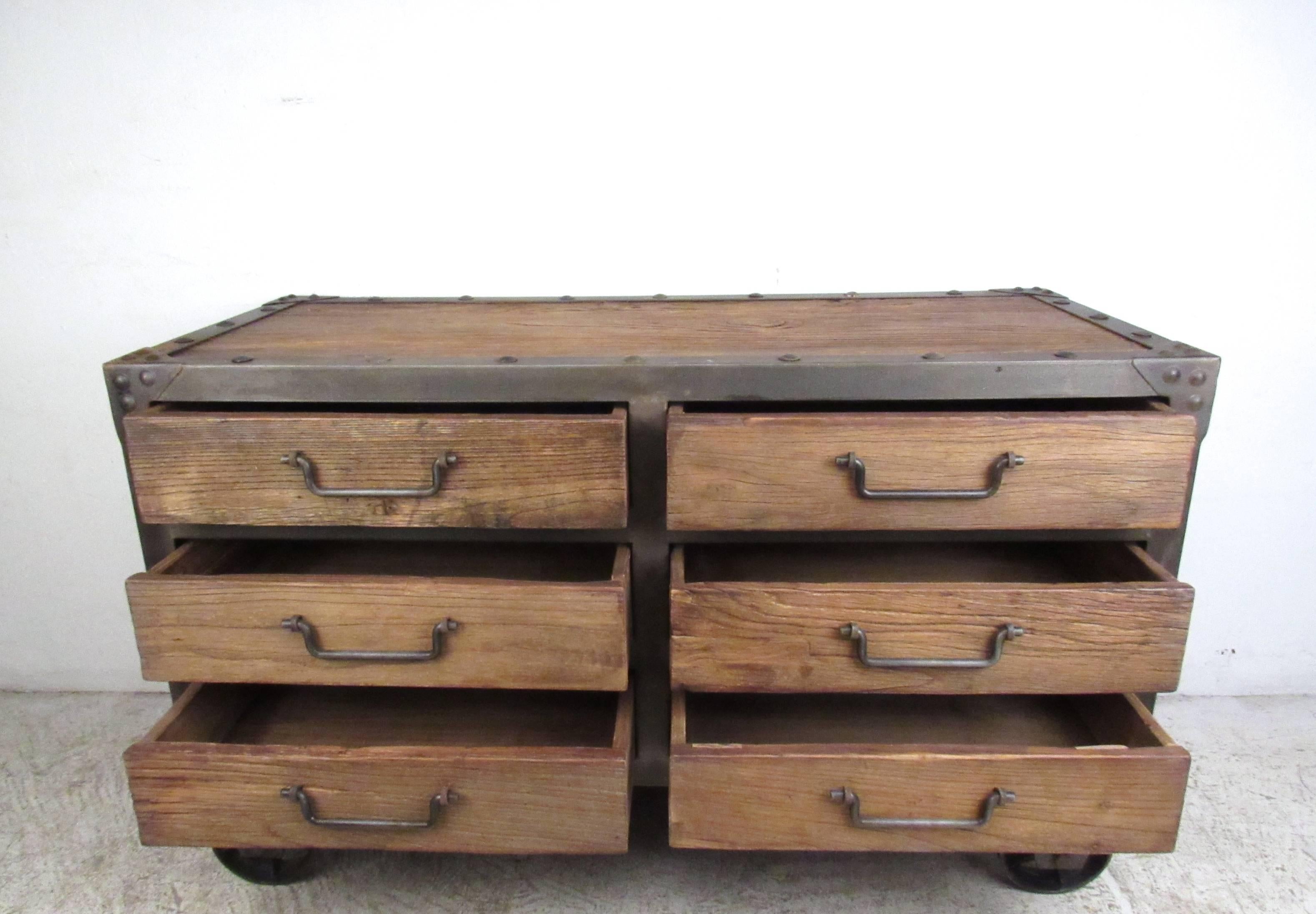 The unique Industrial style of this metal and wood chest of drawers makes a wonderful modern storage option for a variety of interiors. Heavy duty wheels and unique drawer pulls add to the vintage factory feel of the dresser. Please confirm item