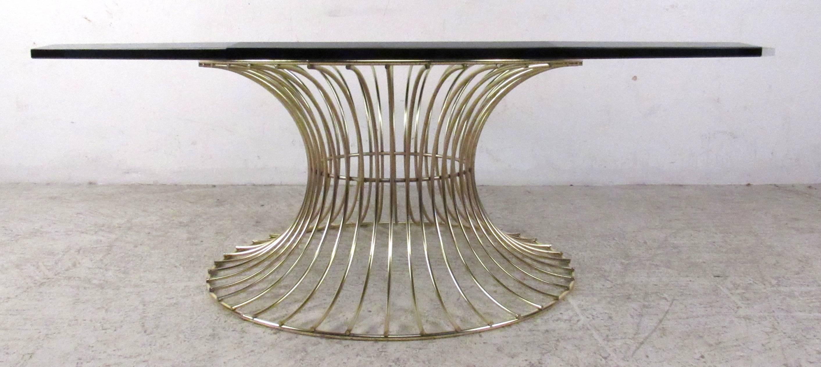 Vintage-modern coffee table featuring beautiful sculpted brass base and solid octagonal glass top.

Please confirm item location NY or NJ with dealer.