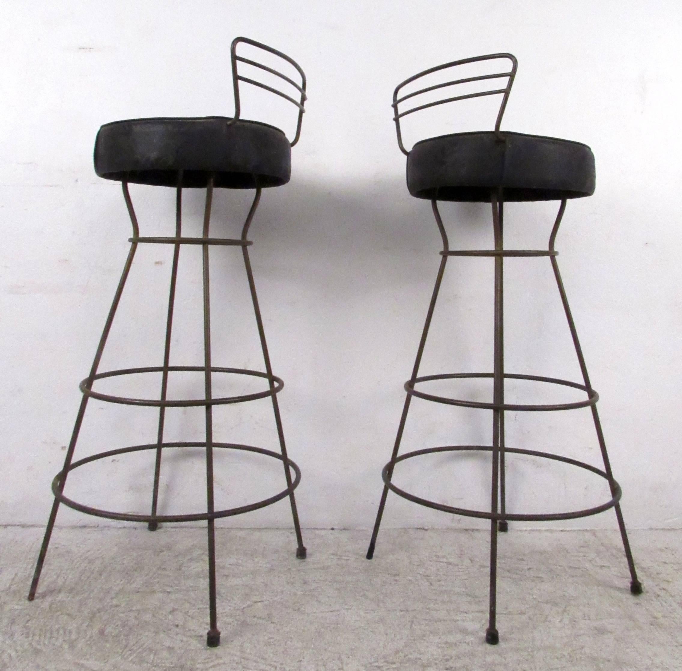 Set of vintage modern stools featuring sculpted iron bases and seat backs with upholstered vinyl seats.

Please confirm item location NY or NJ with dealer.