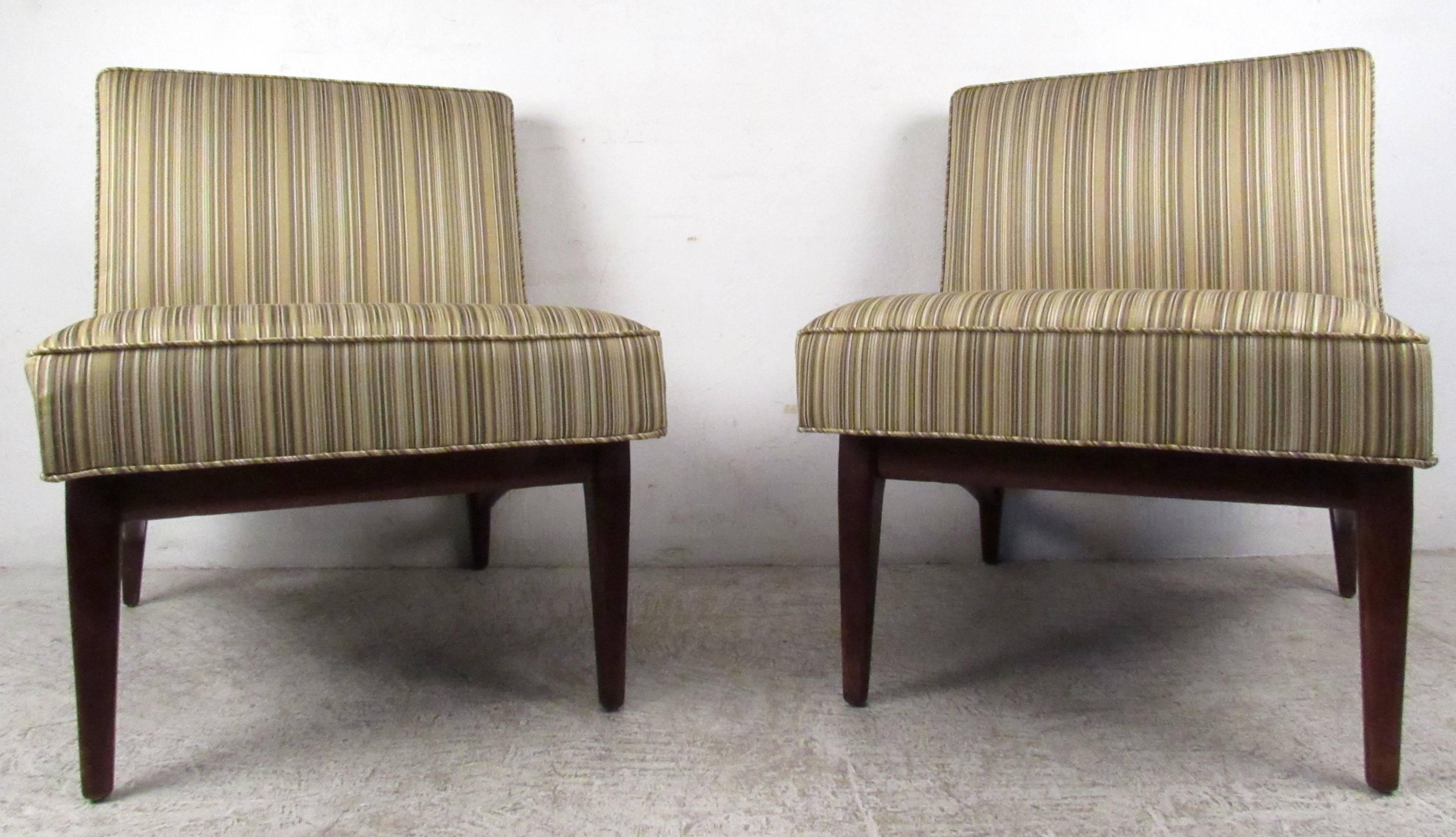 Two vintage-modern walnut slipper chairs with upholstered seat and back, designed in the manner of Jens Risom. This stylish and comfortable set of chairs with tapered legs and thick padded seating makes the perfect addition to any seating