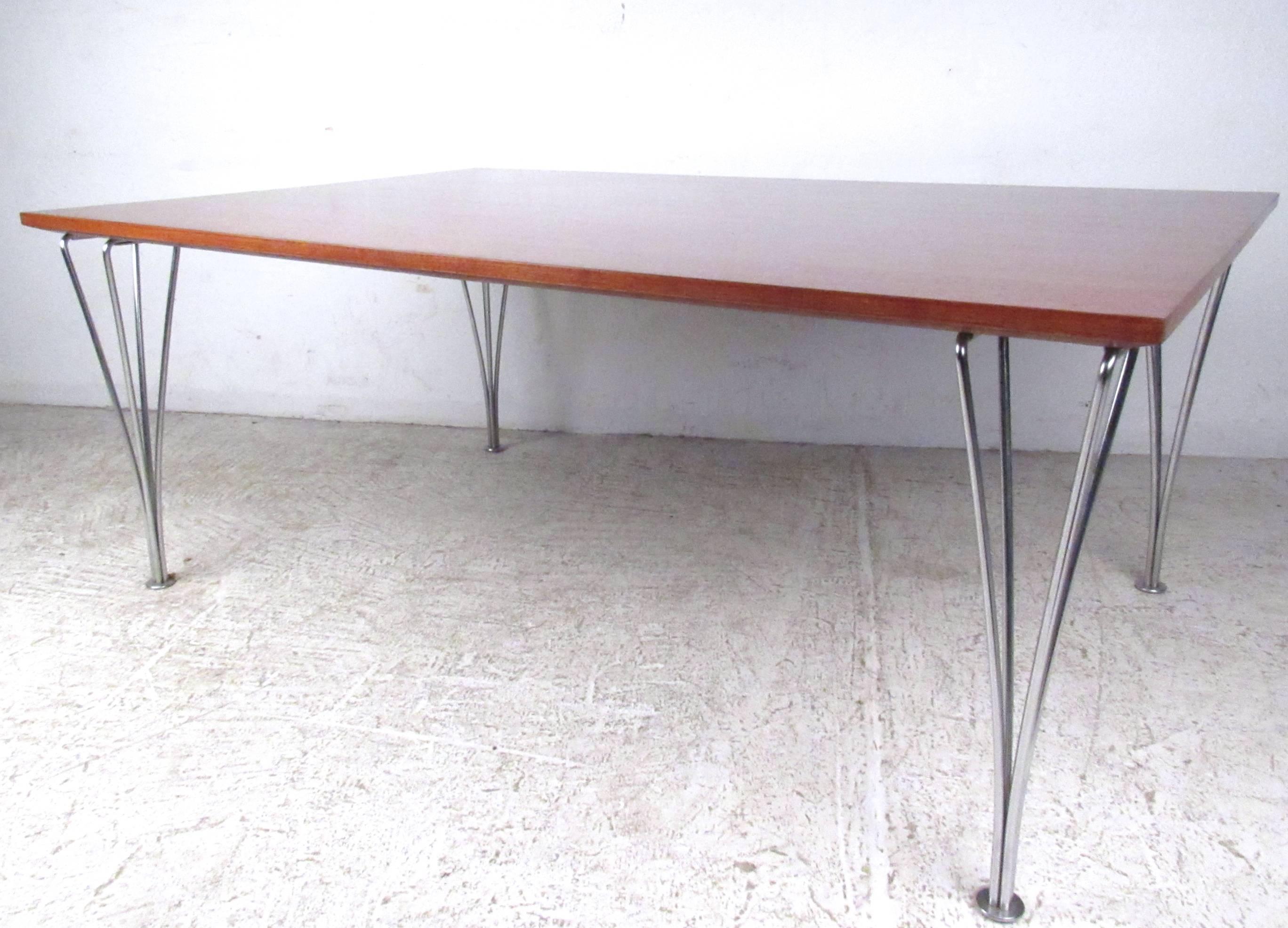 This beautiful vintage table features unique sculptural legs and a wide hardwood top. Unique design attributed to Bruno Mathsson and Piet Hein for Fritz Hansen. Please confirm item location (NY or NJ).