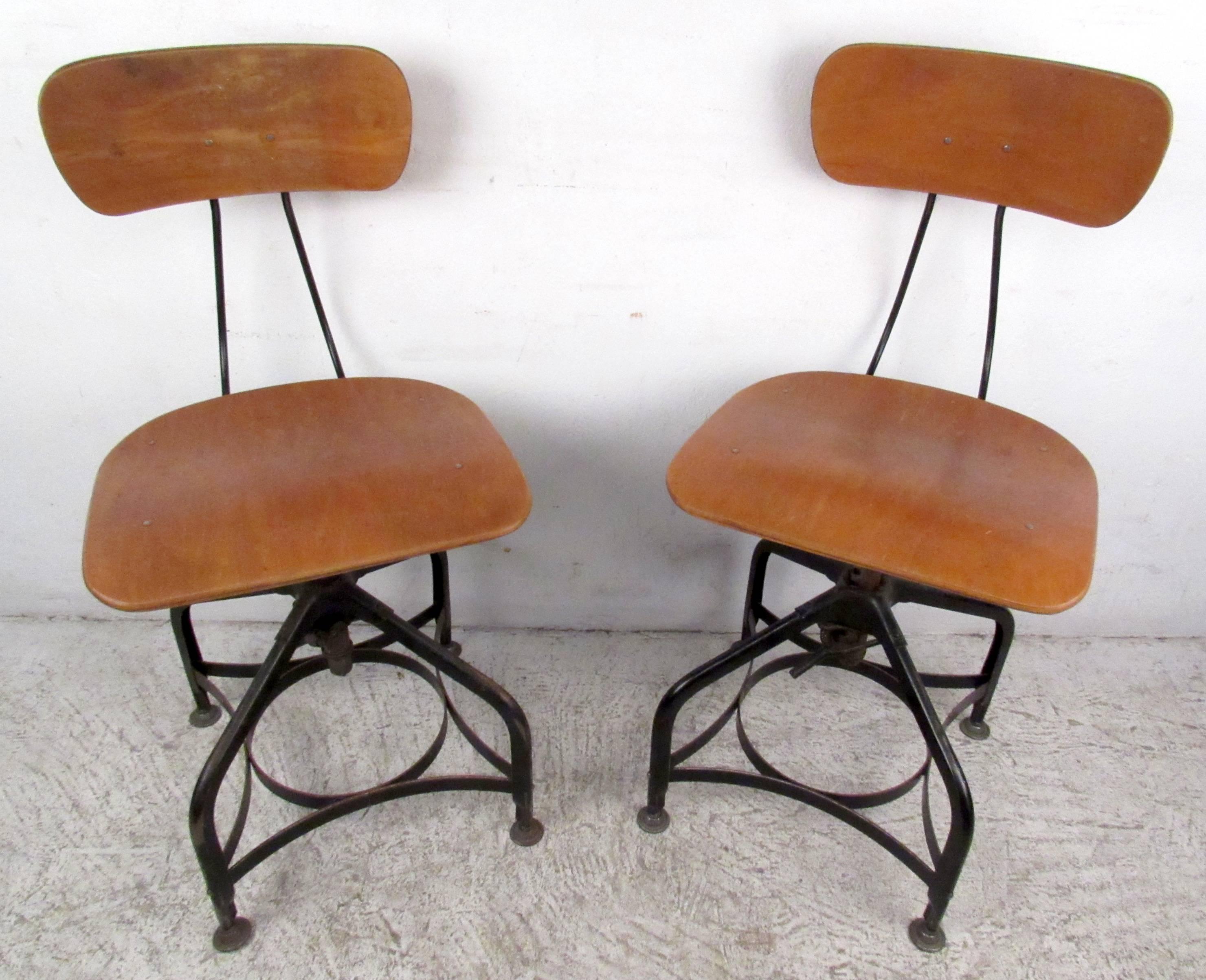 Two vintage modern industrial draftsman stools by Toledo, features bent wood seat and back with adjustable iron bases.

Height adjustment seat: 16.25 - 31 - back - 20.75 - 35.5.

Please confirm item location NY or NJ with dealer.