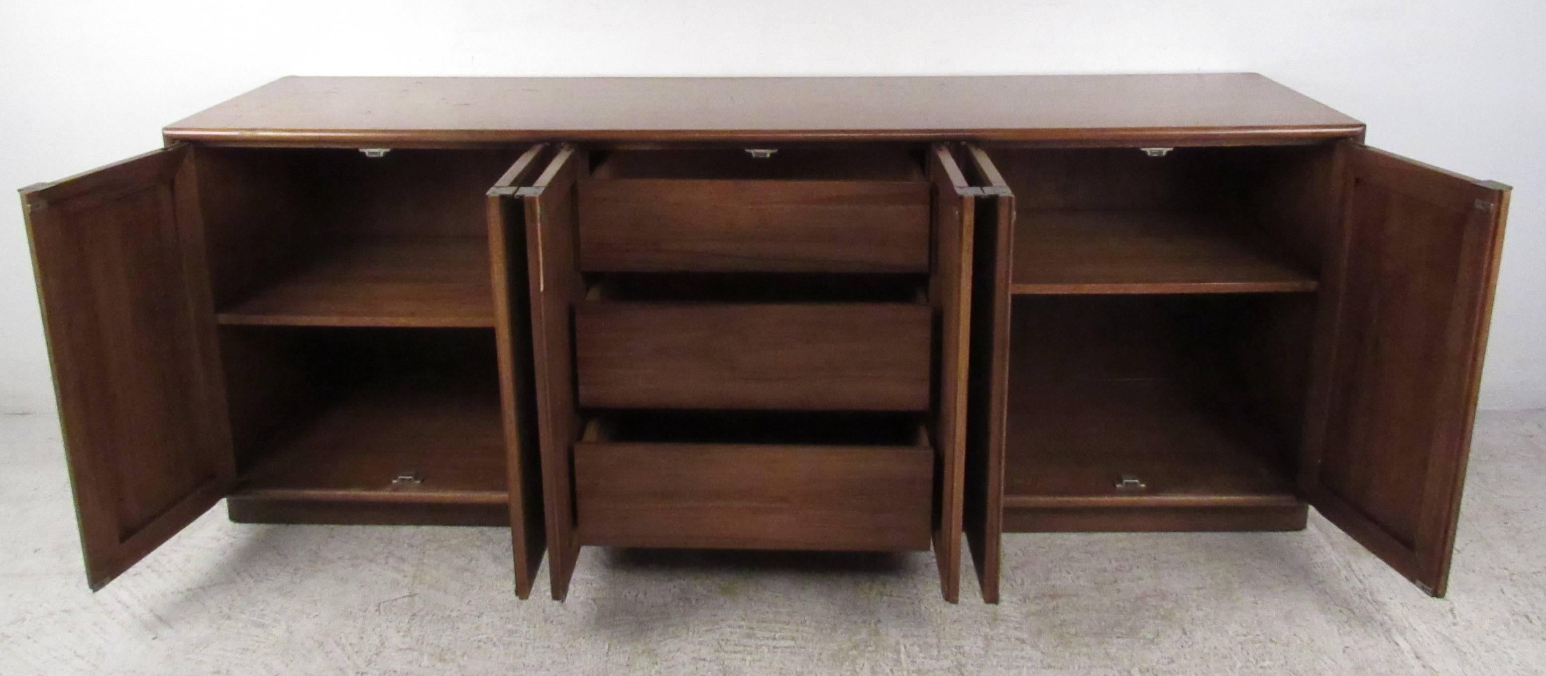 Vintage-modern sideboard featuring cane front with interior drawers and shelving, designed by John Stuart.

Please confirm item location NY or NJ with dealer.