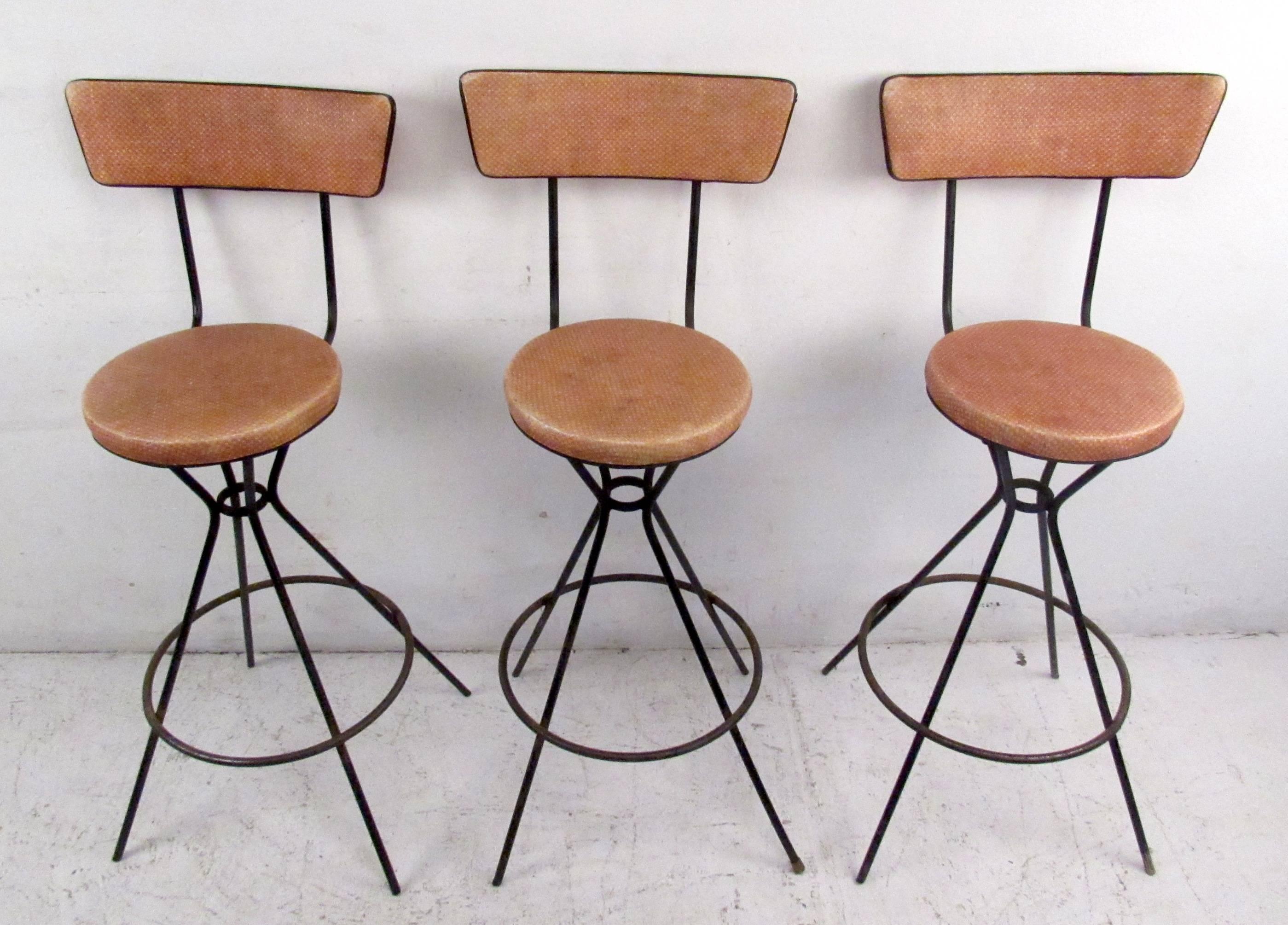 Set of vintage-modern barstools featuring sculpted iron swivel bases and vinyl upholstery.

Please confirm item location NY or NJ with dealer.