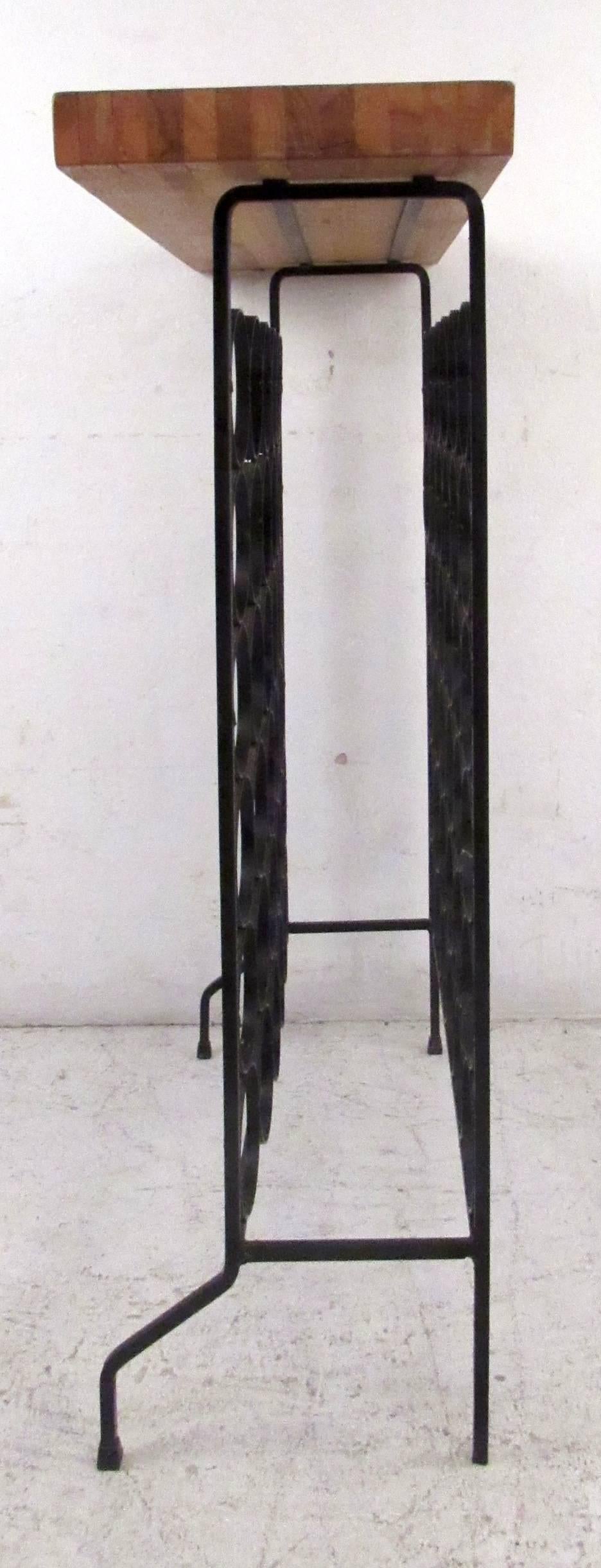 Vintage-modern wine rack featuring sculpted iron base with butcher block top.

Please confirm item location NY or NJ with dealer.