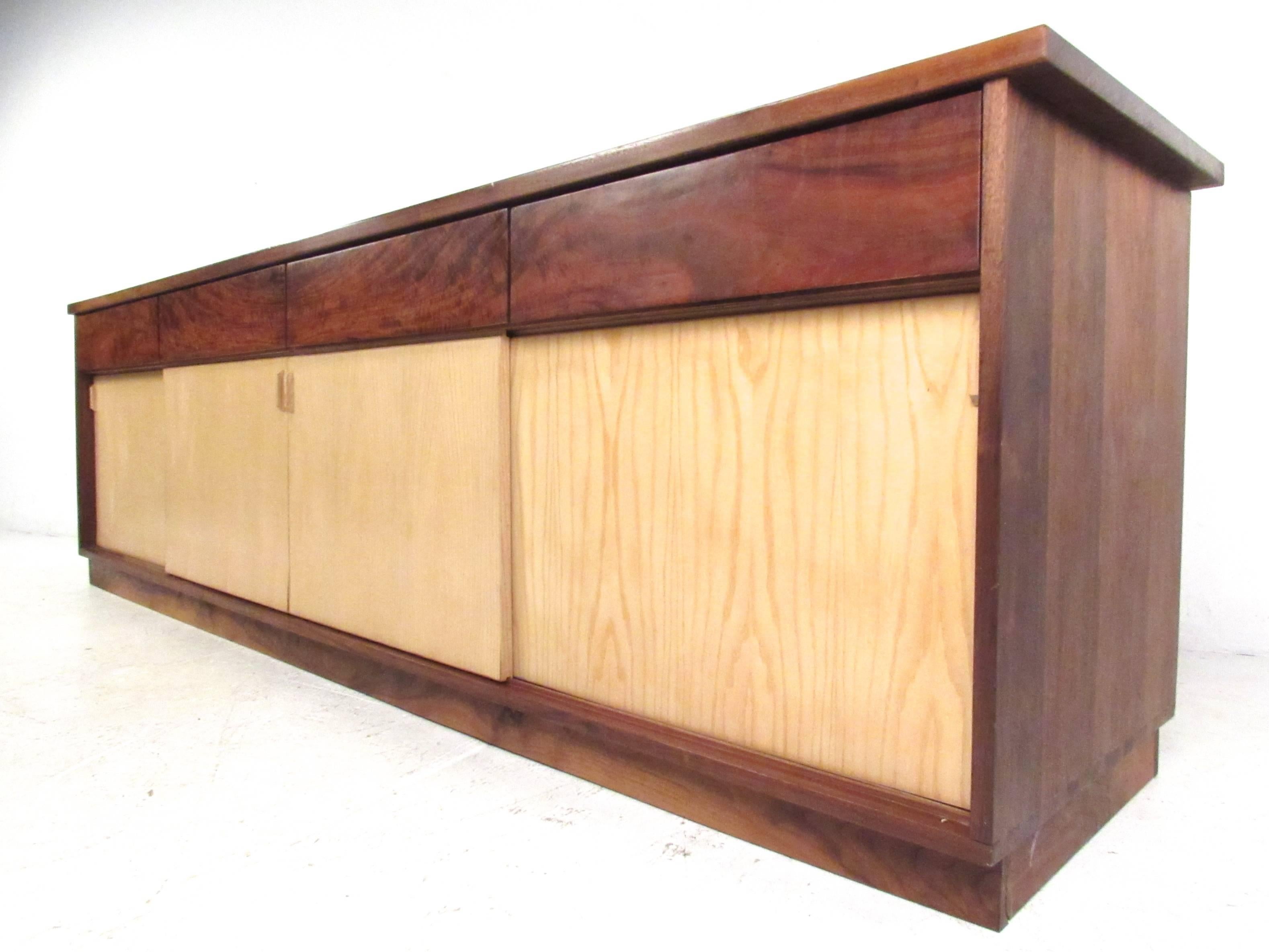 This stunning large-scale office credenza features beautiful two-tone construction, ample storage space and drawers for added storage. Beautiful rosewood finish contrasts wonderfully with the light finish sliding doors. Dovetail construction add to