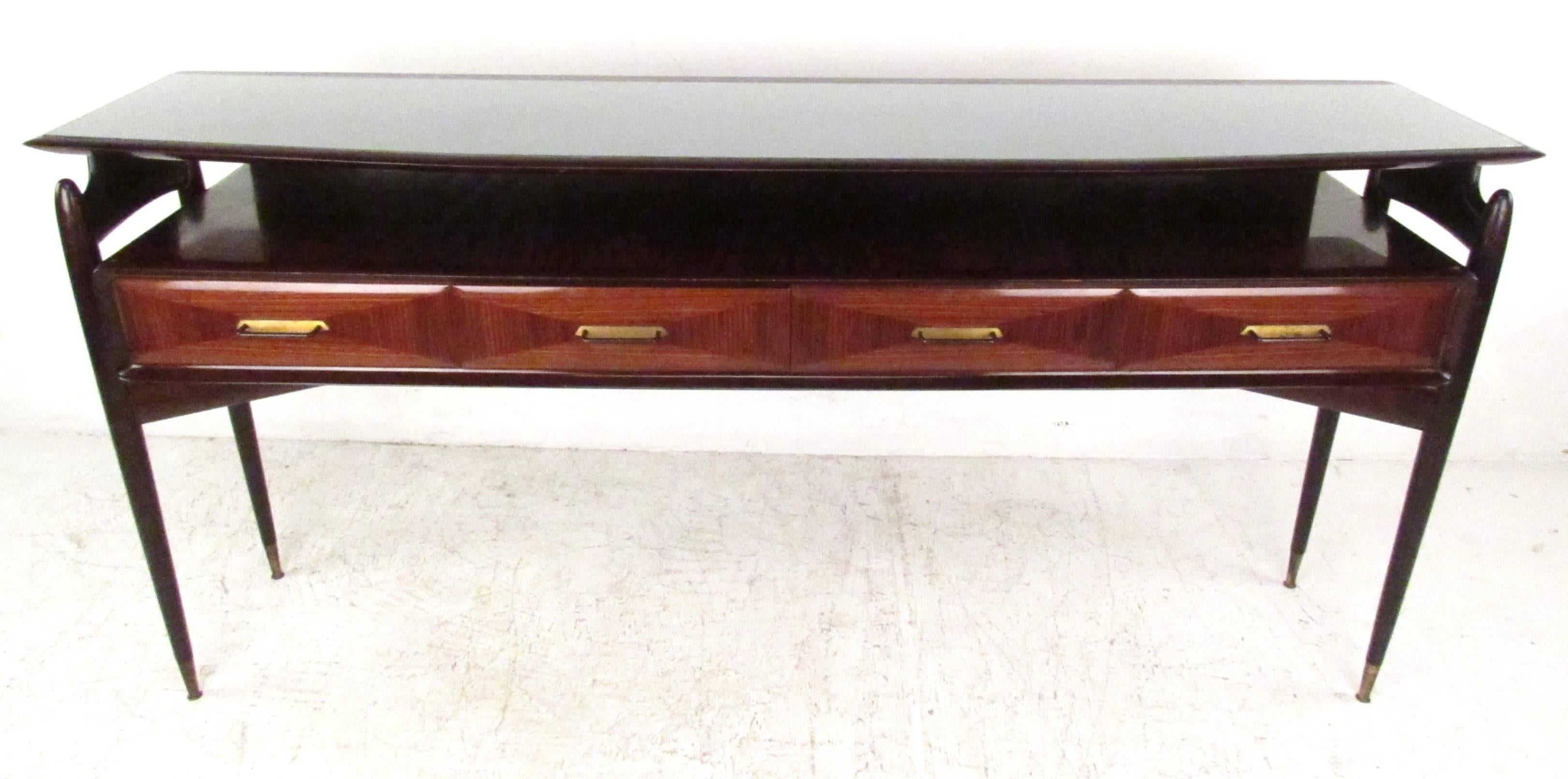 Elegant Italian modern four-drawer server with floating glass top, long tapered legs with brass sabots, and sculptural wood detailing with a high gloss finish. 

Please confirm item location (NY or NJ) with dealer.
 