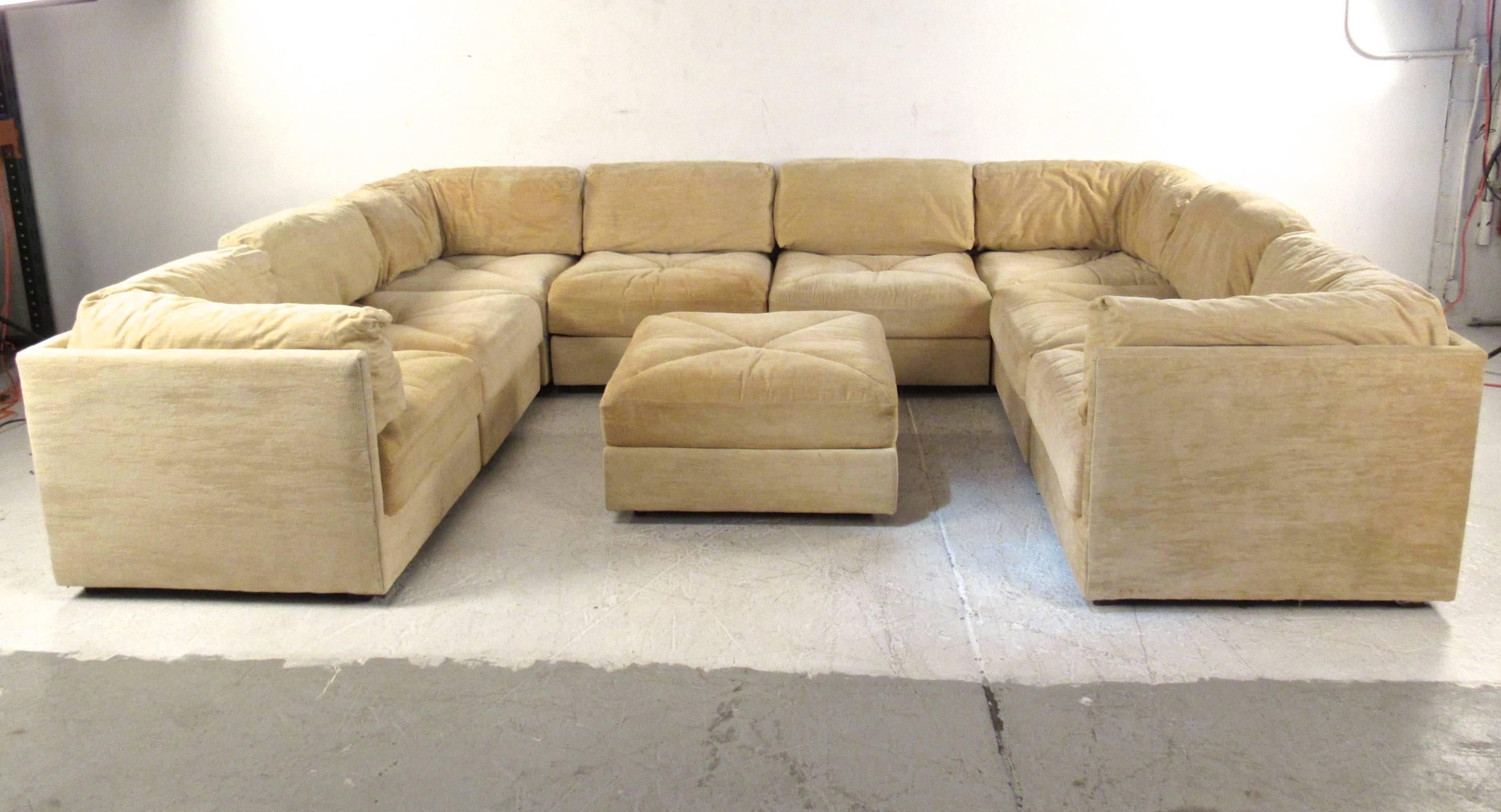 This impressive nine-piece mid-century modern sectional sofa by Selig Furniture offers an expansive seating arrangement. Large ottoman included, makes a substantial addition to home or business.  Combining vintage style with comfort and