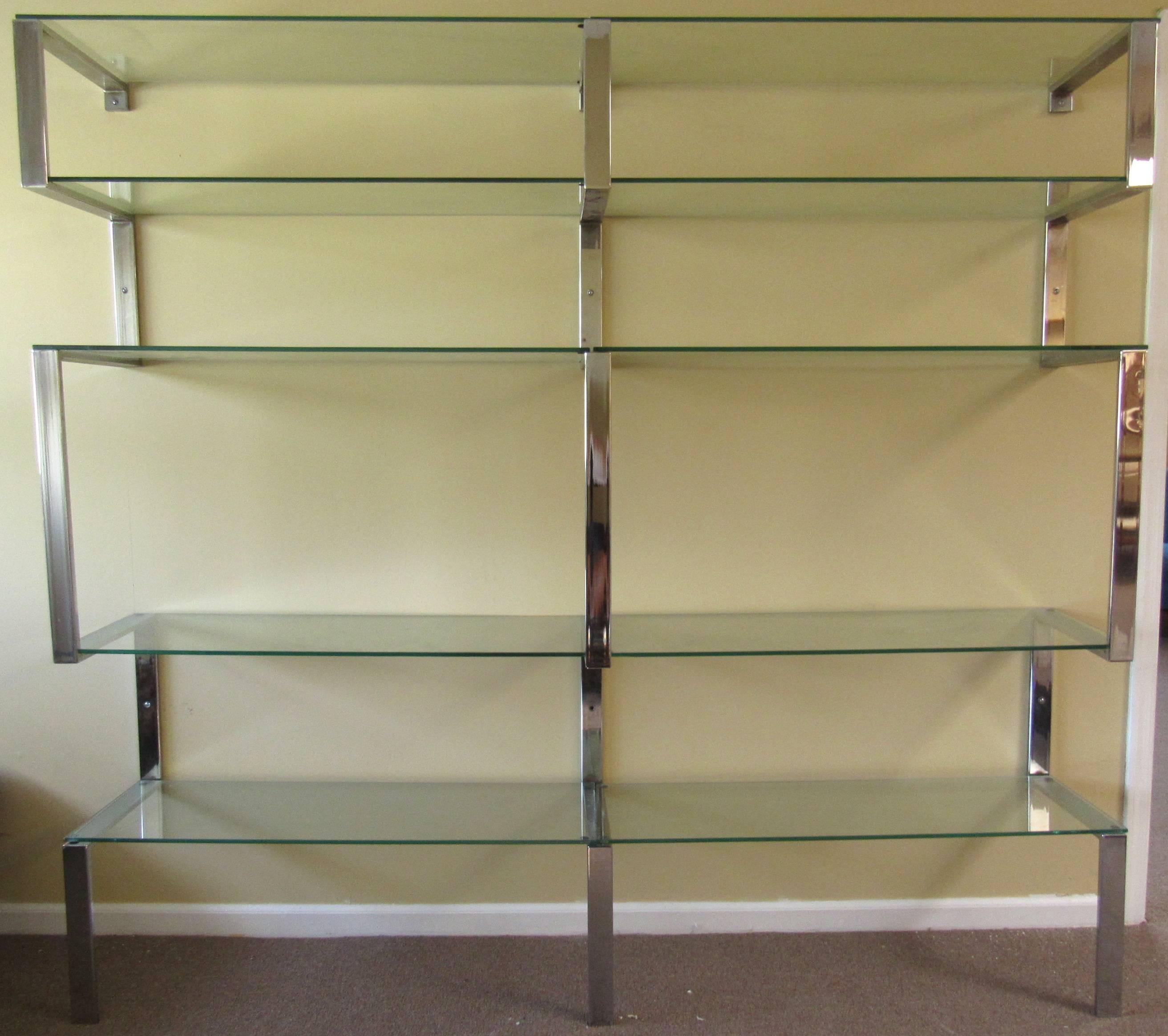 This stylish three-piece chrome finish shelving unit makes a clean modern addition in the style of mid-century designer Milo Baughman. Bent chrome wall shelf secures to support glass shelves, perfect for home or shop display. Please confirm item