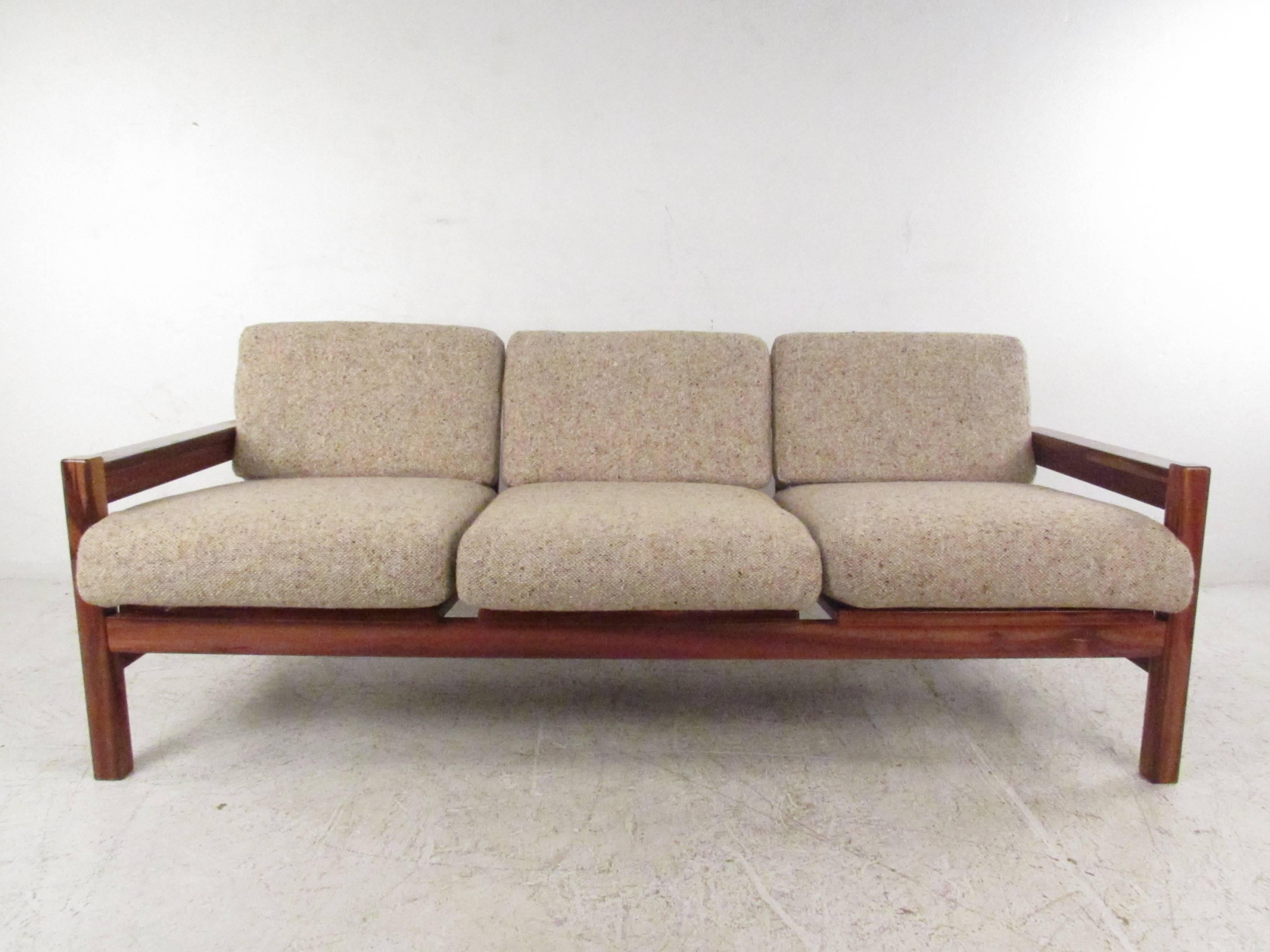 This is unique Israeli sofa features a sturdy rosewood frame, slat back and comfortable strap seating. Vintage rosewood finish, stylish modern design and comfortable upholstery make this sofa a great addition to seating in any room. Please confirm