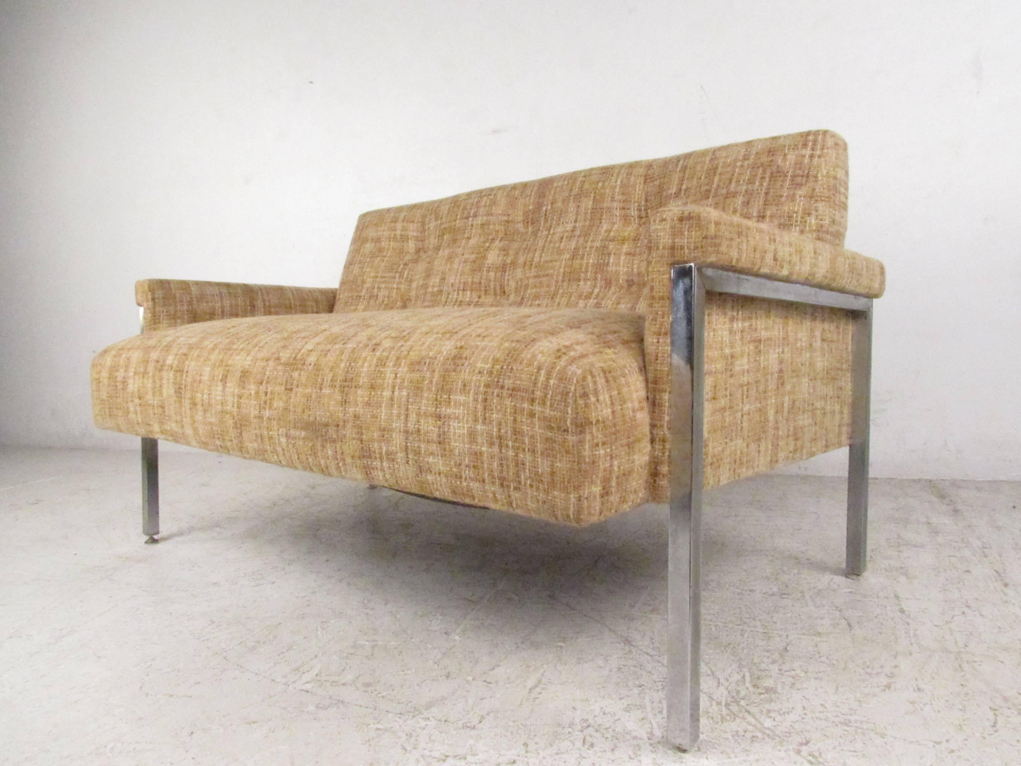 This vintage two-seat sofa or loveseat features comfortable tufted upholstery, chrome Baughman style legs, and a simple yet stylish Mid-Century Modern design. Perfect additional seating for home or office, please confirm item location (NY or NJ).