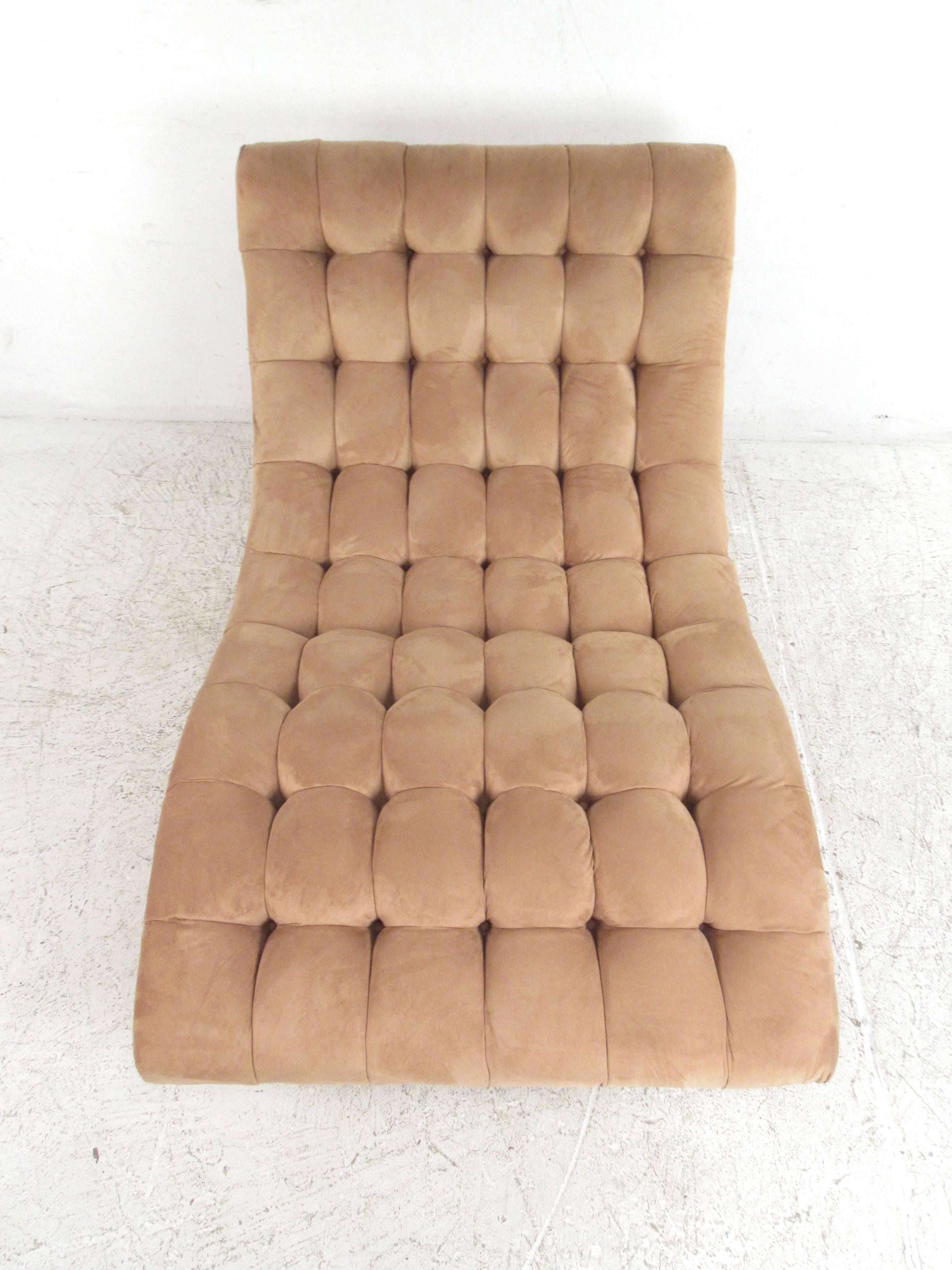 This tufted vintage chaise lounge chair features a dramatic sculptural shape, with impressive tufted upholstery. This mix of mid-century style and comfort makes this a fantastic addition to any seating layout in a variety of interiors. Please