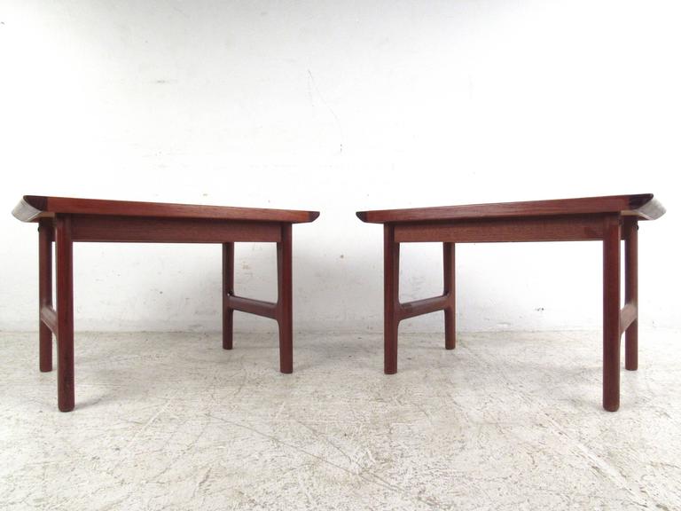 This matching pair of vintage end tables feature quality Mid-Century craftsmanship in a beautiful Danish teak finish. Perfect height for use in any room; please confirm item location (NY or NJ).