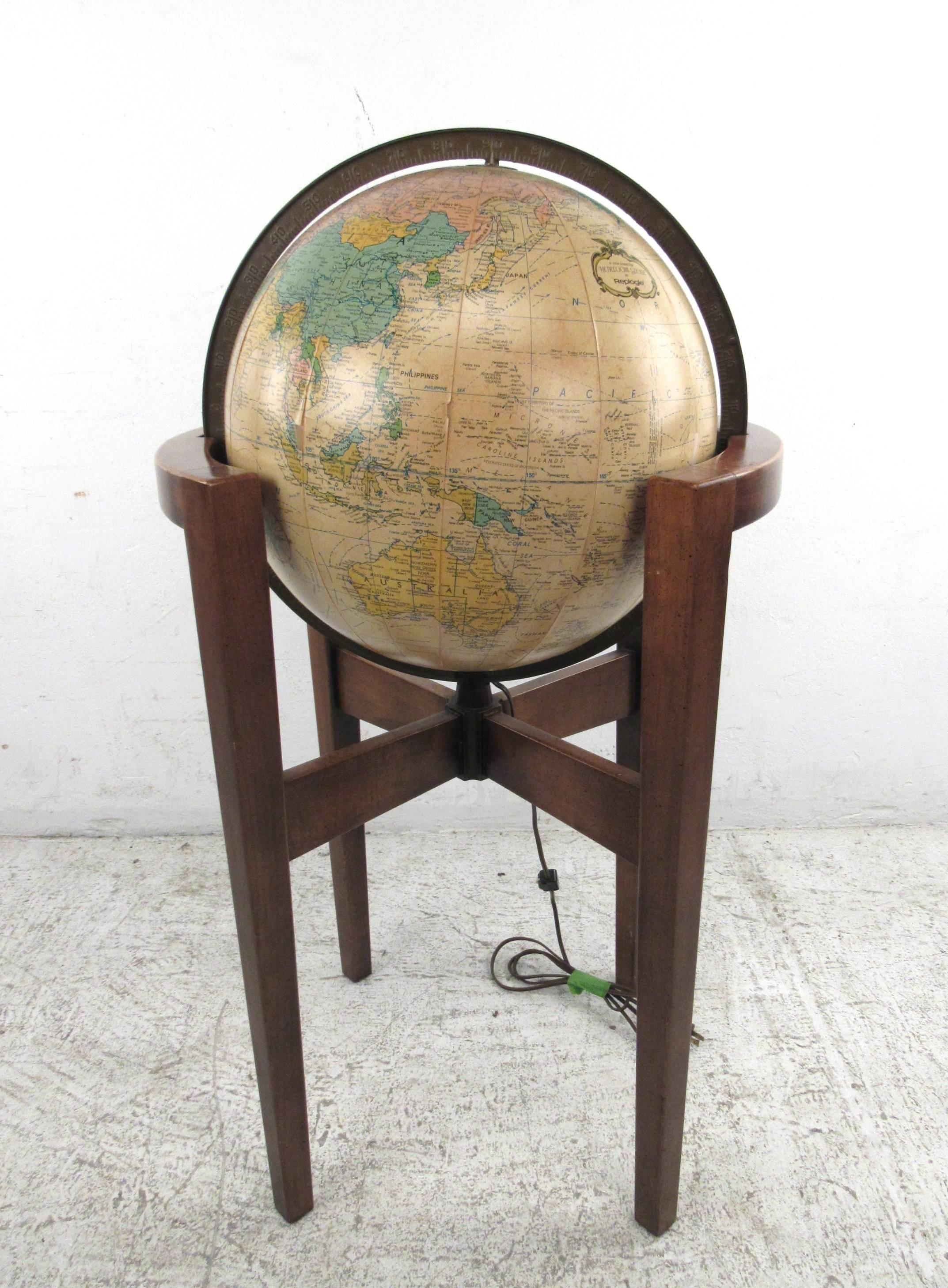 This illuminating globe by Replogle features a unique antique style 16 inch globe set in a Mid-Century style tapered leg stand. Freely spins on it's axis and makes a unique vintage addition to any setting, great for study or office! Please confirm