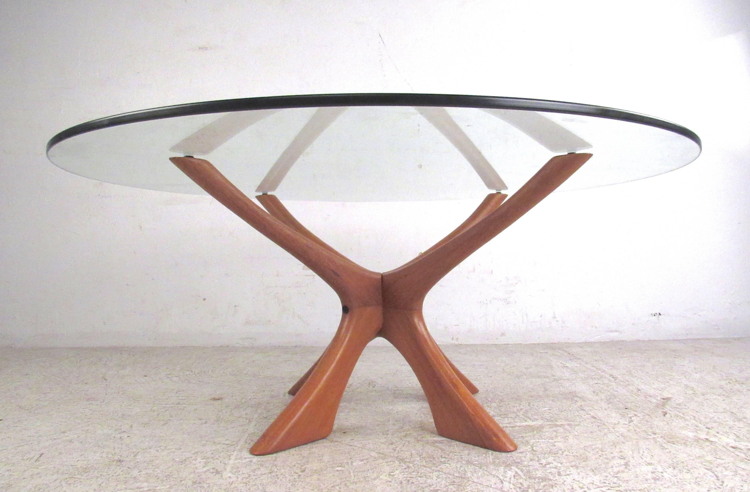 This sculpted jacks style coffee table features unique mid-century design with a wonderful natural finish. The thick glass top floats impressively on the graceful sculpted base. . Please confirm item location (NY or NJ).