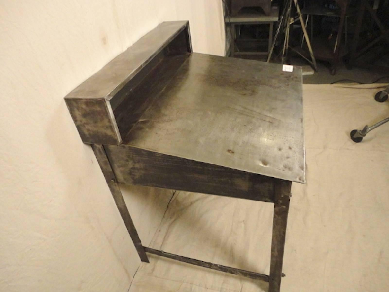 Machine age style Foreman's desk redone in a bare metal style finish. This piece is great for a restaurant, to be used with a drafting stool or standing.

(Please confirm item location NY or NJ with dealer).