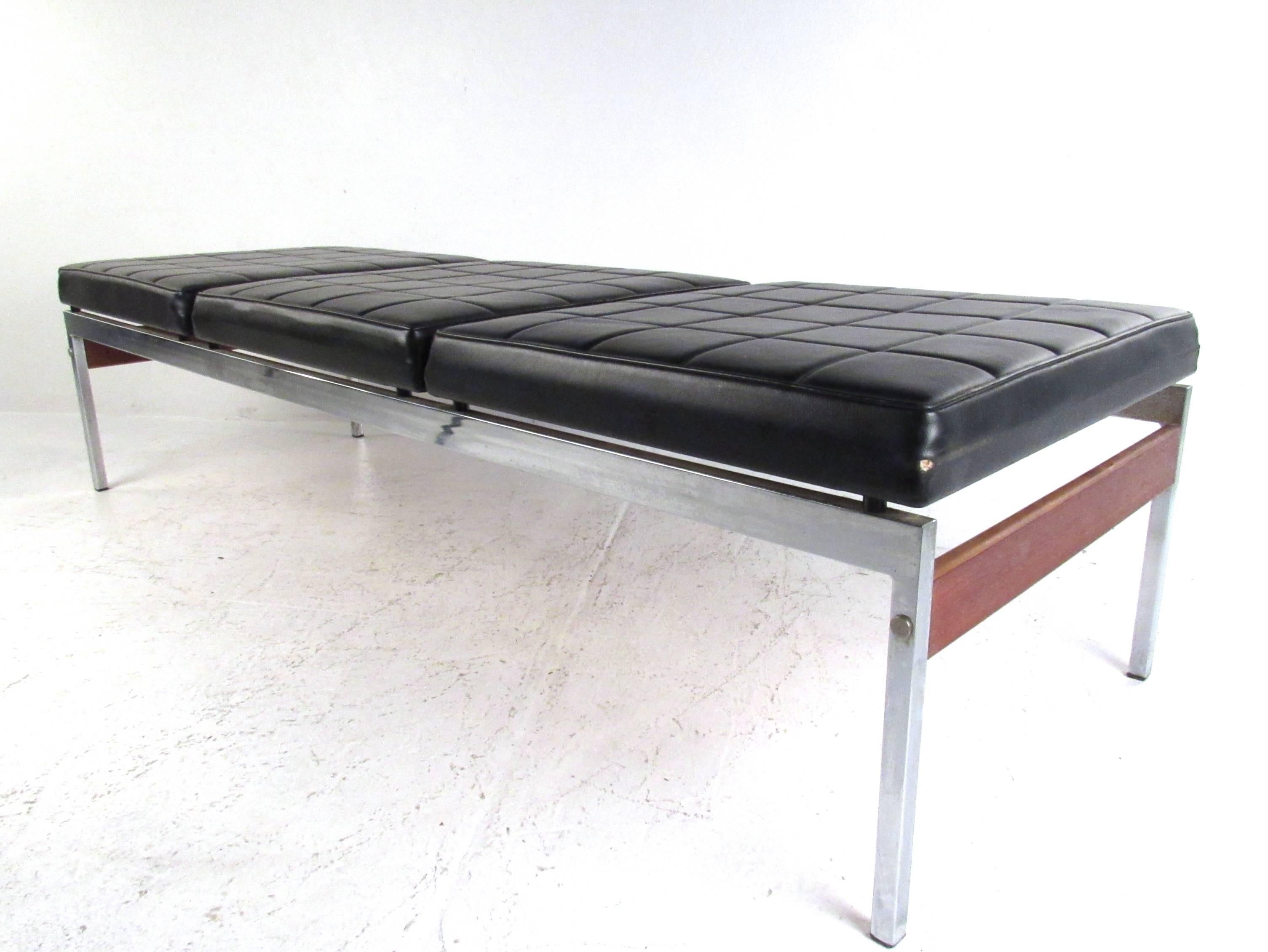 This unique Mid-Century bench features three comfortably upholstered seats mounted on a sturdy chrome finish frame. Cross work stitching on the vinyl adds to the design of the piece while the vintage hardwood side stretchers add stability and style.