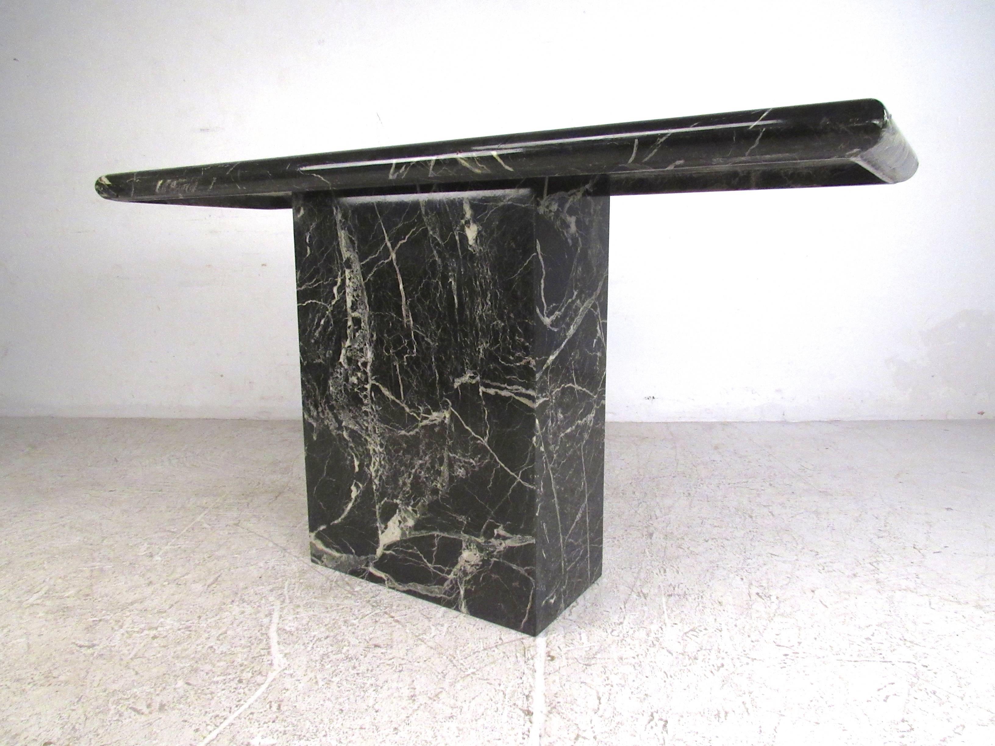 This unique vintage marble finish pedestal table is the perfect addition to foyer, hall or office. Black marble tabletop fitted to matching marble pedestal base. Unique piece for display or stylish accent. Please confirm item location (NY or NJ).