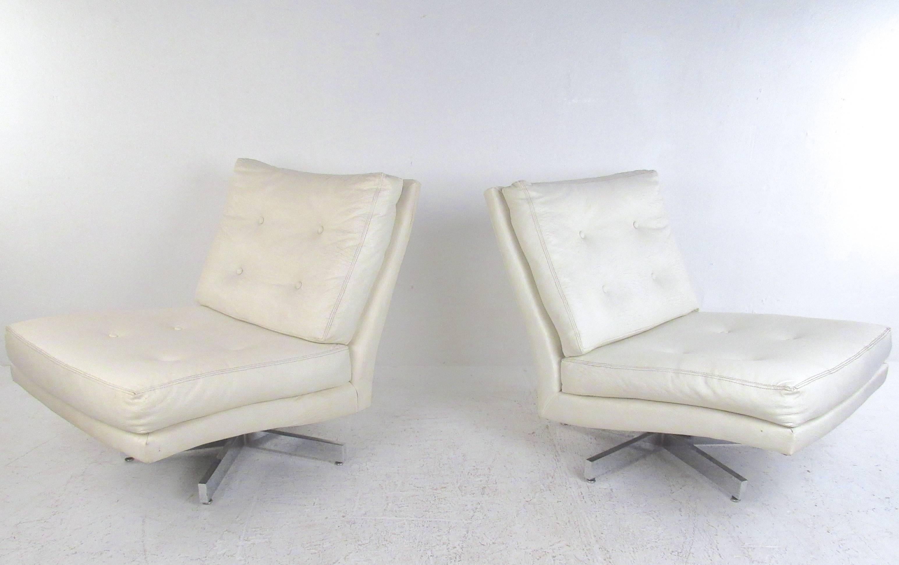 This beautiful pair of vintage vinyl swivel chairs for Thayer Coggin feature the stylish Mid-Century design of Milo Baughman. Tufted seats, slipper style design, and chrome swivel base add to the charm of the pair. Original tags still intact,