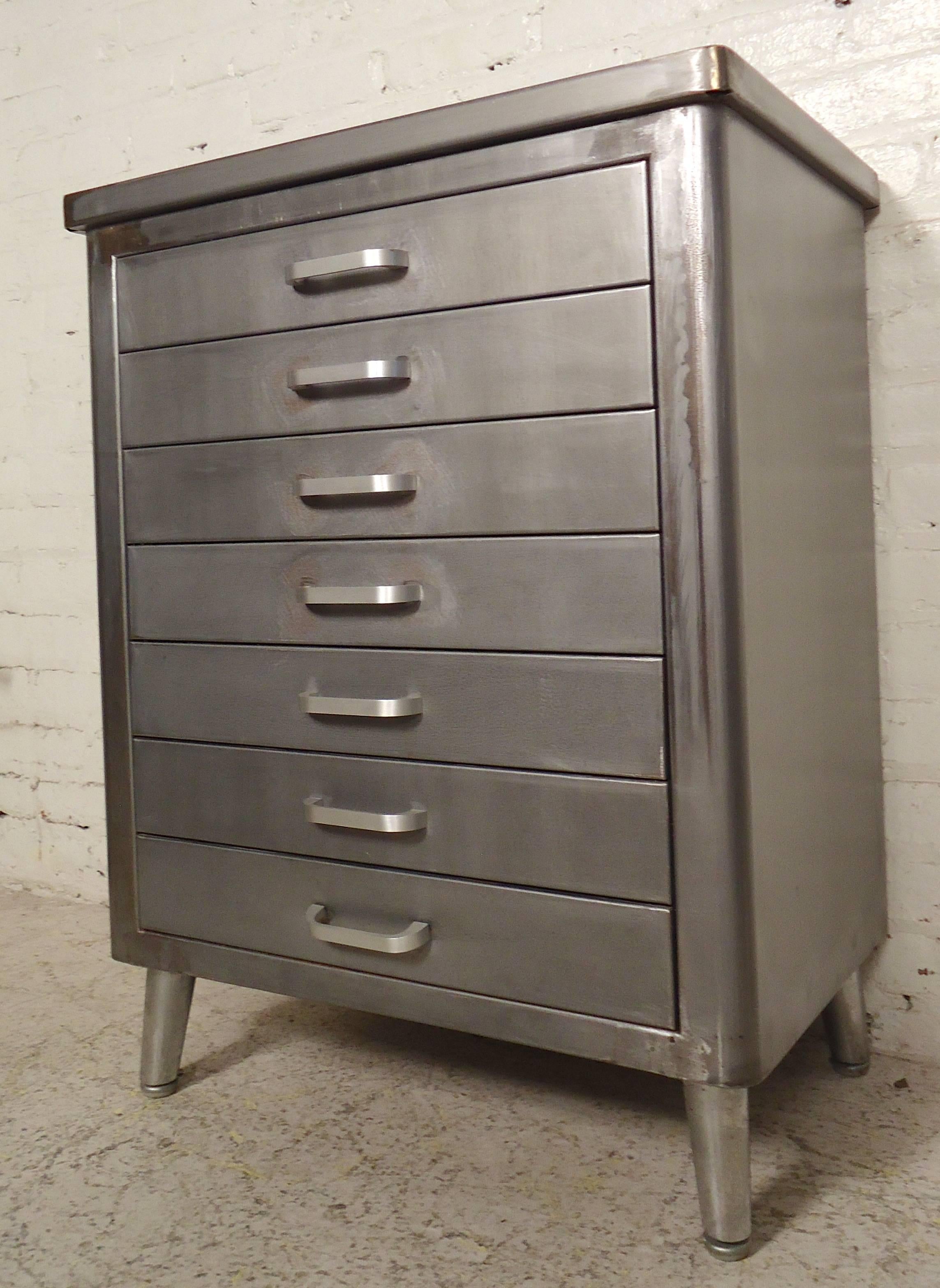 Seven-drawer vintage cabinet has been refinished and features splayed metal legs. Great for bathroom or kitchen storage.

(Please confirm item location NY or NJ with dealer).
 