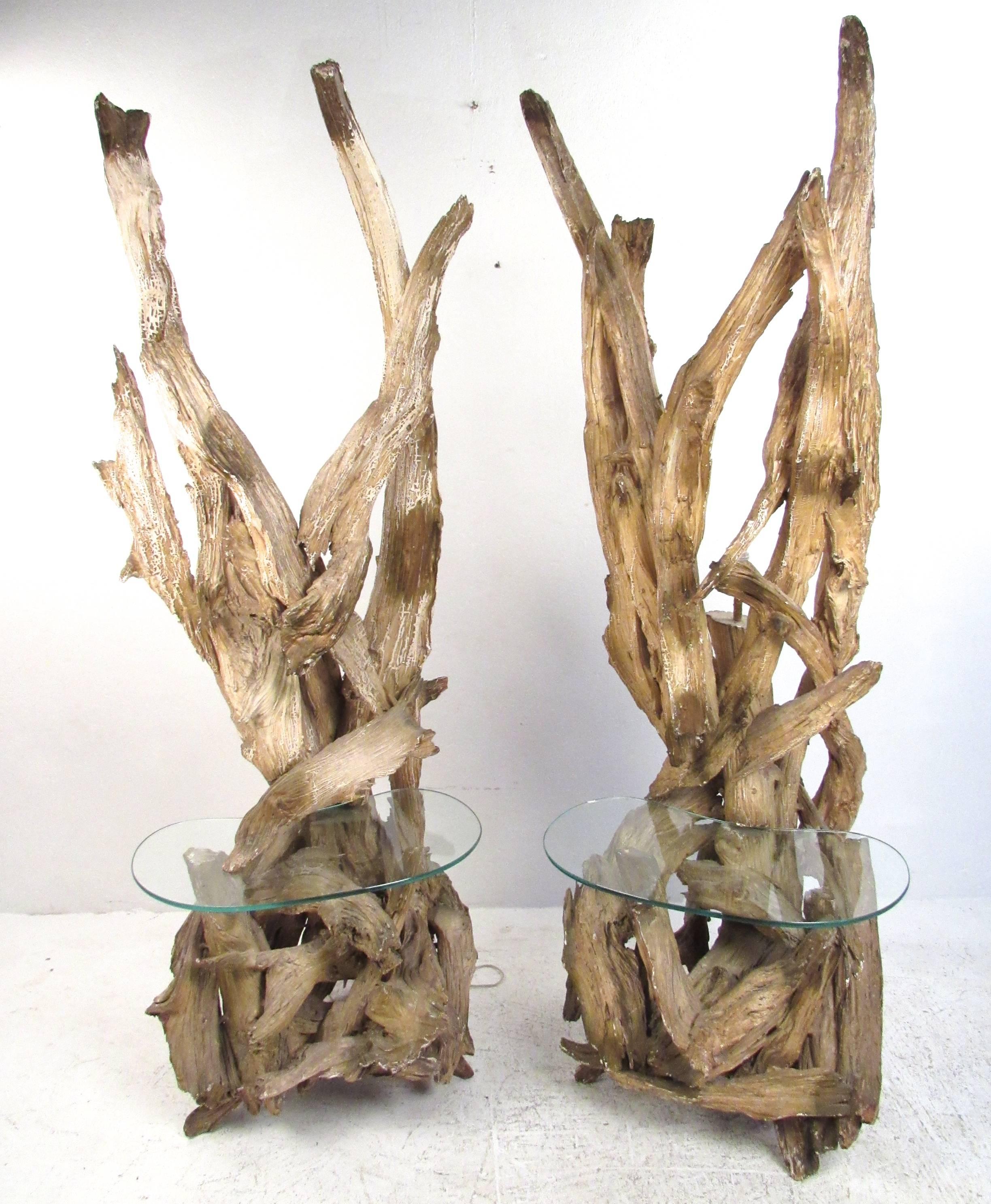 This pair of large vintage floor lamps features unique driftwood construction with a wonderful sculptural appeal. Rustic natural beauty is accented with kidney shaped glass table inserts and tall cylindrical shades. Unique pair of large-scale floor