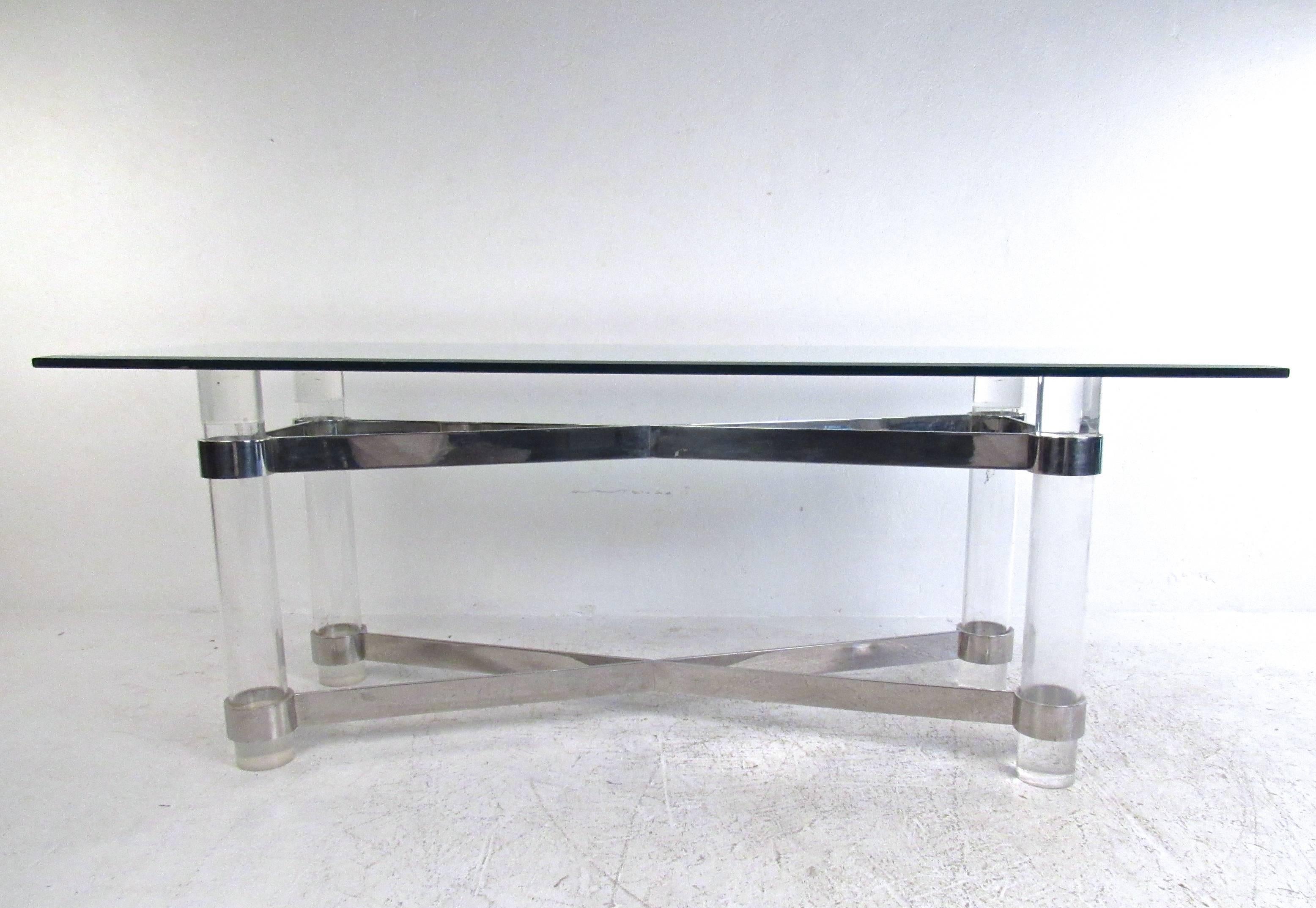This stunning vintage table in the style of Karl Springer features thick Lucite posts connected with chrome X-style frame which adds stability and style to the piece. Thick beveled glass top makes this an excellent display table in a variety of