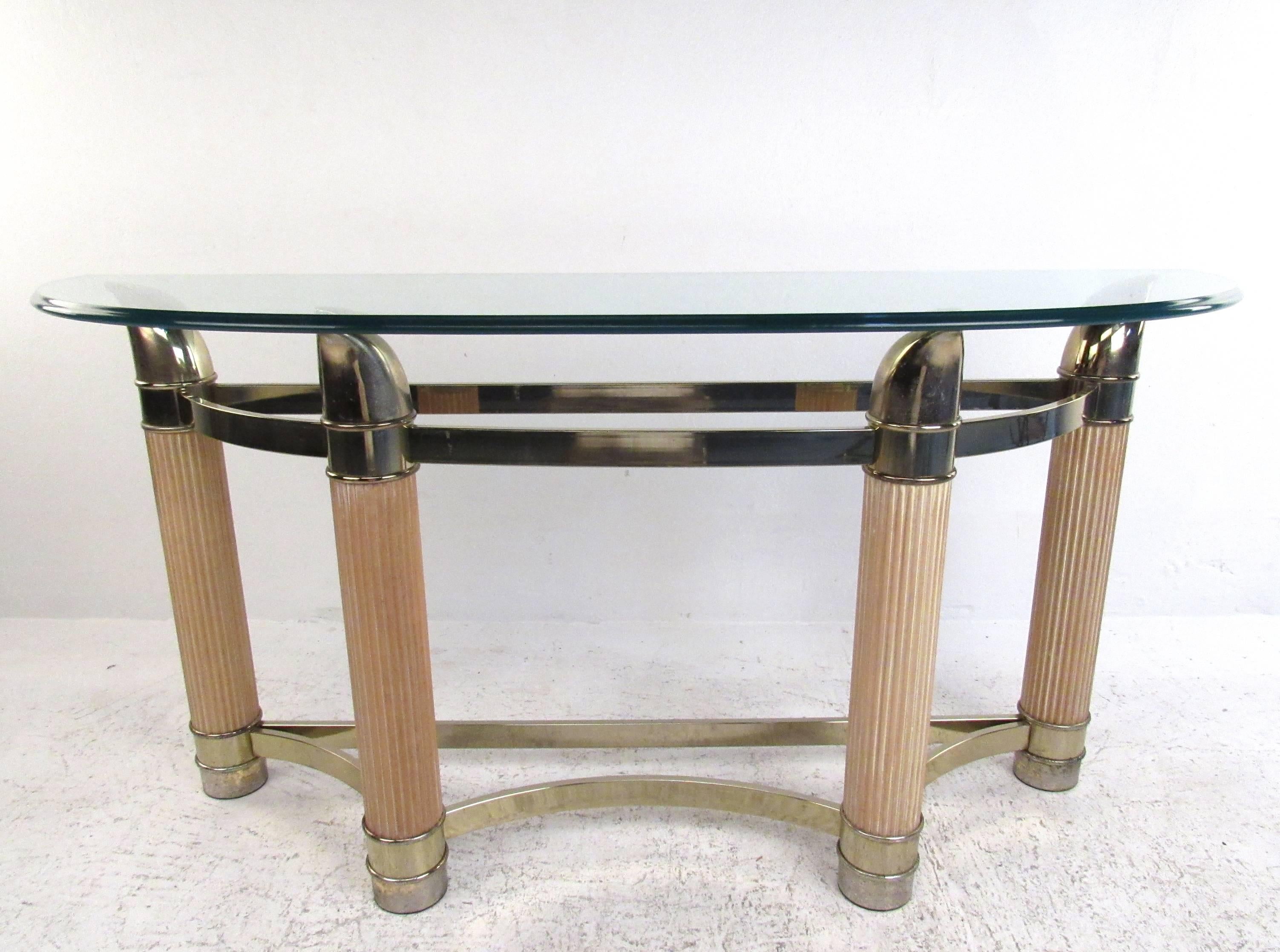 This stylish vintage table features sturdy construction with wonderful decorative details. Brass finish with unique sculpted points add to the elegance of this Mid-Century demilune table. Perfect display table for entryway, foyer, or hall use,