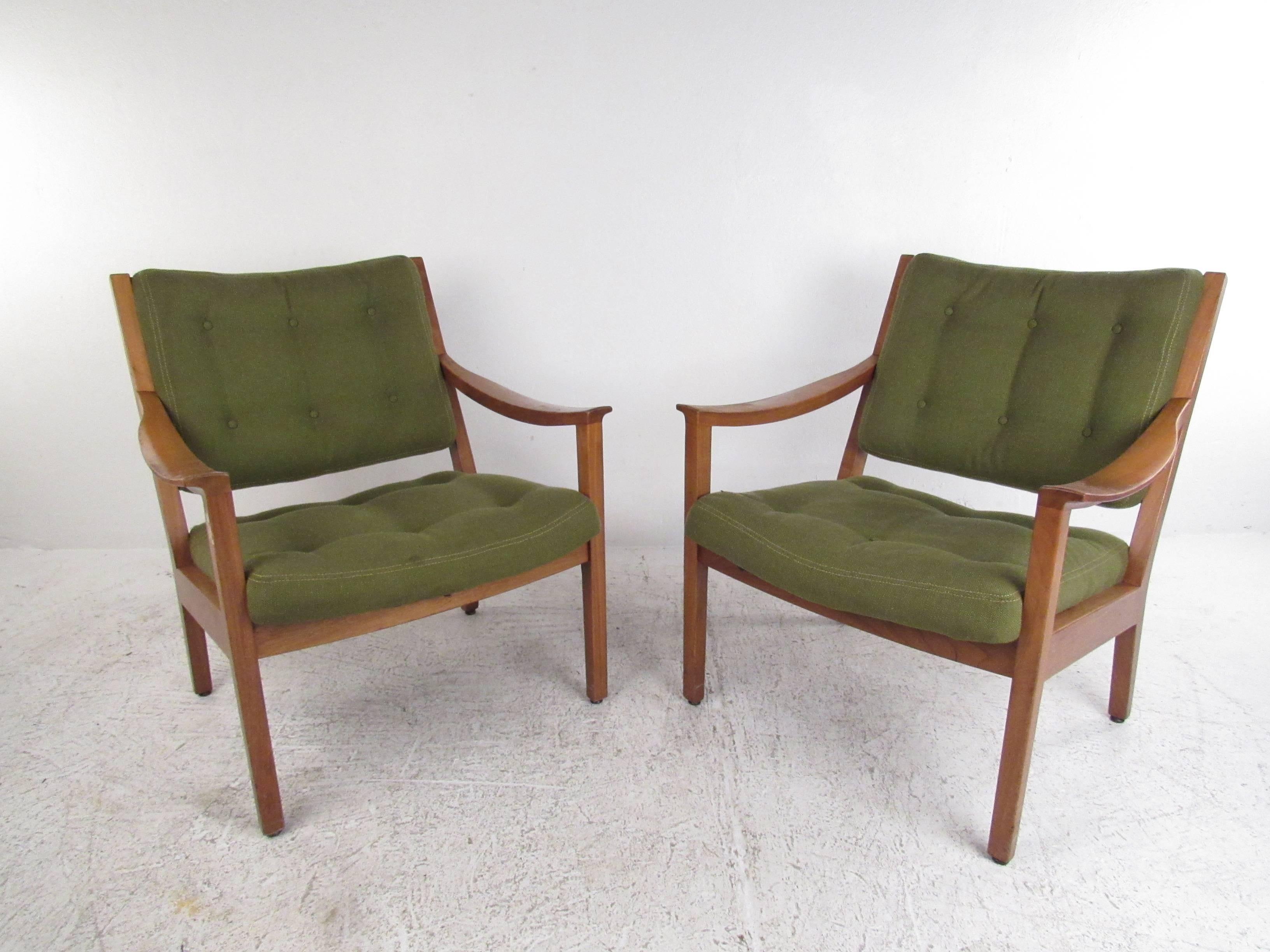 This pair of vintage armchairs by the Gunlocke Company features stylish Mid-Century design with a solid walnut frame. Tufted vintage fabric and comfortable seat proportions add to the classic charm of the pair. Please confirm item location (NY or