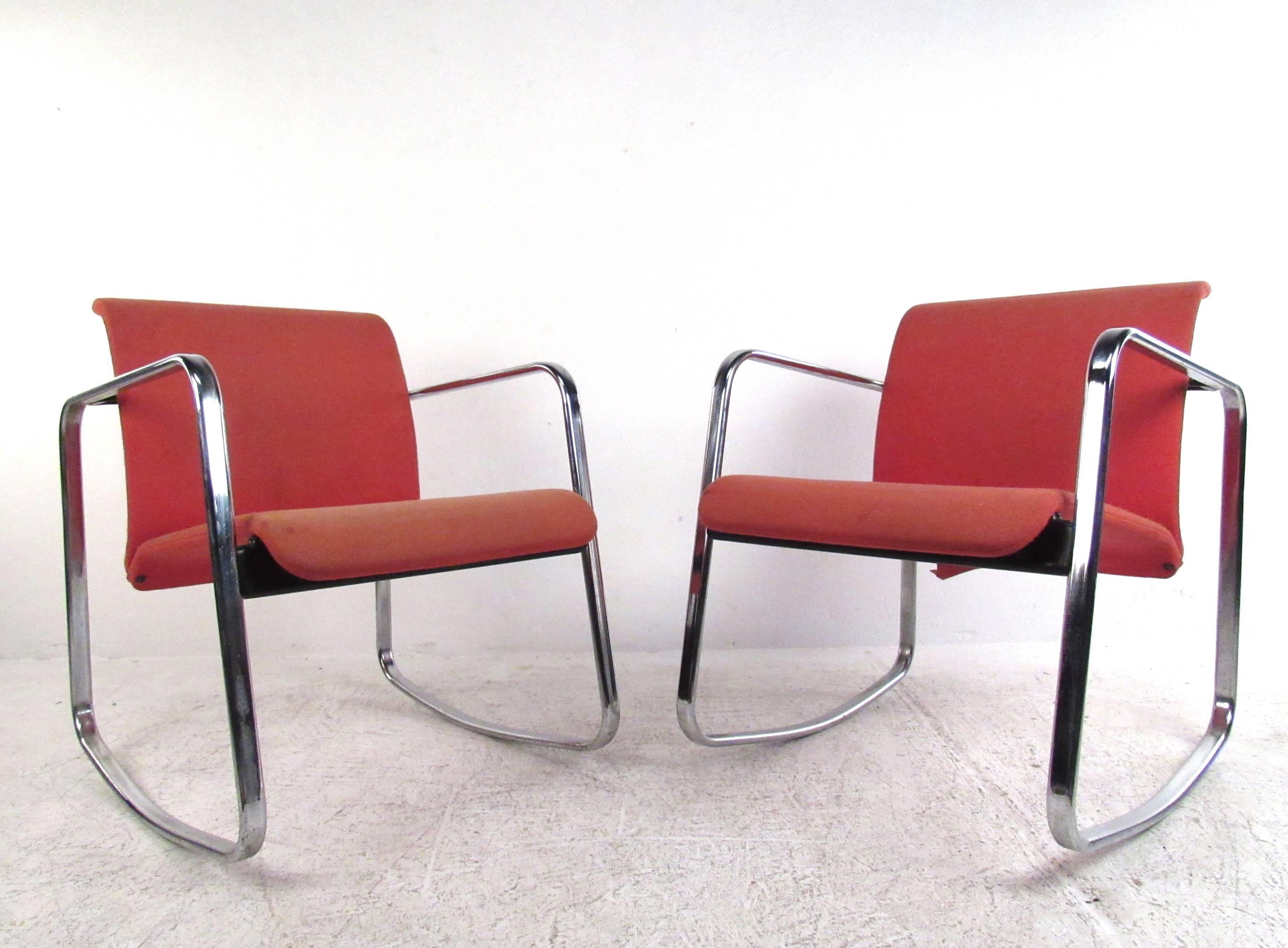 This vintage pair of chrome frame rocking chairs features the stylish design of Peter Protzmann as presented by Herman Miller. Unique modern shape, iconic chrome design, and comfortably sculpted seat backs make this pair of lounge chairs a unique