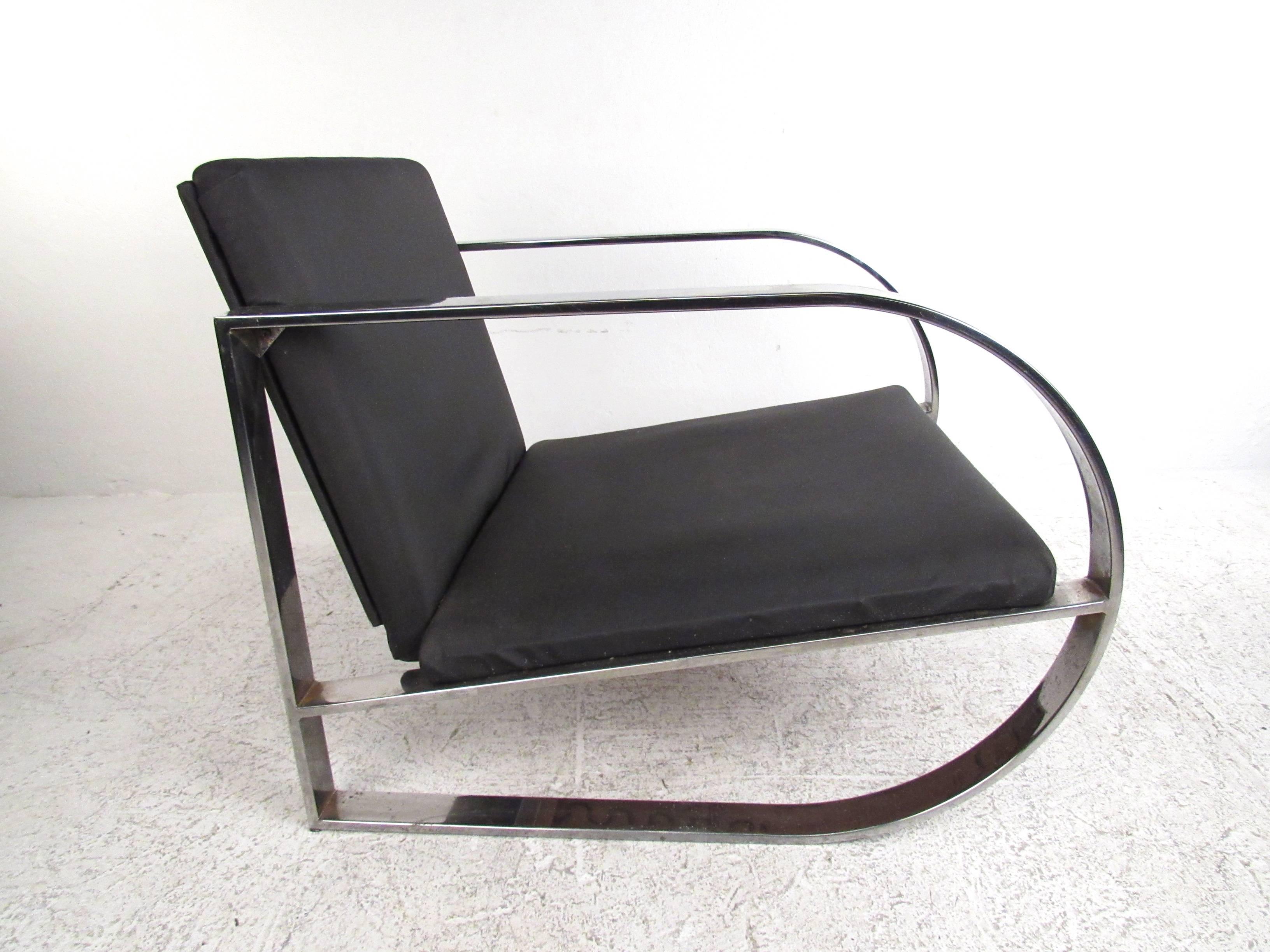 This sleek and stylish modern lounge chair features a unique chrome frame with an extra wide seat. Mid-Century Modern design with comfortable upholstery makes this a wonderful addition to any setting. Please confirm item location (NY or NJ).