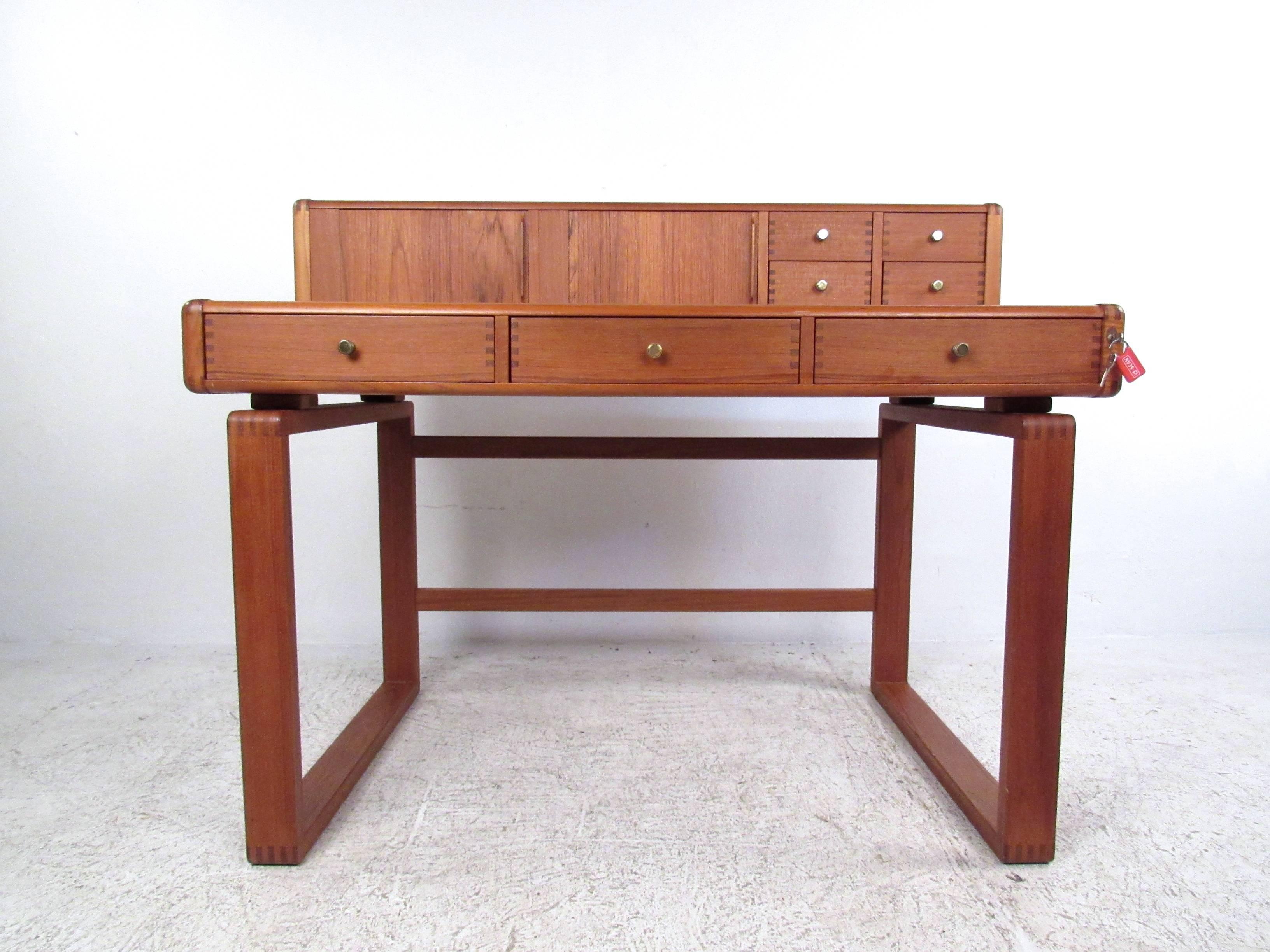 This unique sled leg desk offers a compact yet versatile desk, with a removable teak topper which provides added storage for organization. This beautiful vintage desk features sturdy dove-tail construction and makes an impressive addition to home or