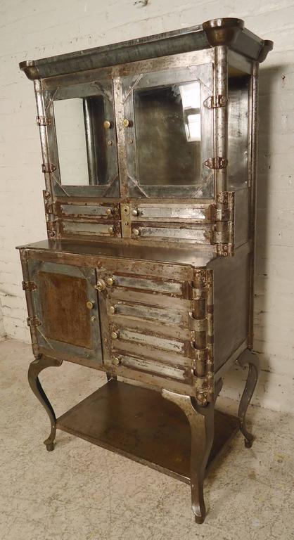 Vintage industrial dental cabinet, restored in a rugged machine age style finish. Ample storage including top glass cabinet, swing doors, middle cabinet, and bottom shelf. Great display cabinet for kitchen or bathroom.

(Please confirm item