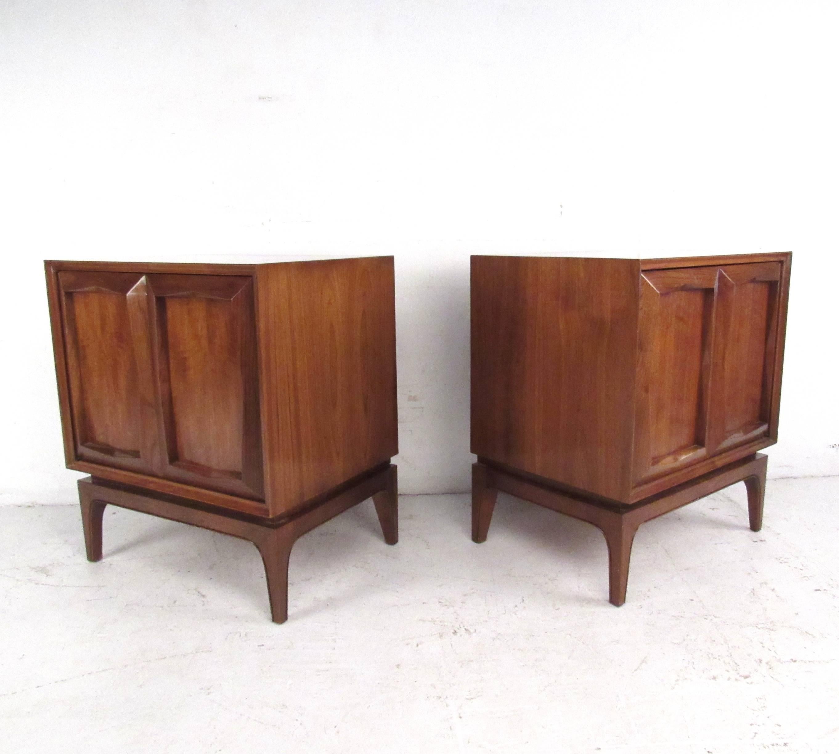 This vintage pair of nightstands feature spacious cabinet storage with shelves for added organization. Sculpted door fronts, tapered legs and a rich walnut finish make these an excellent addition to any Mid-Century interior. Please confirm item