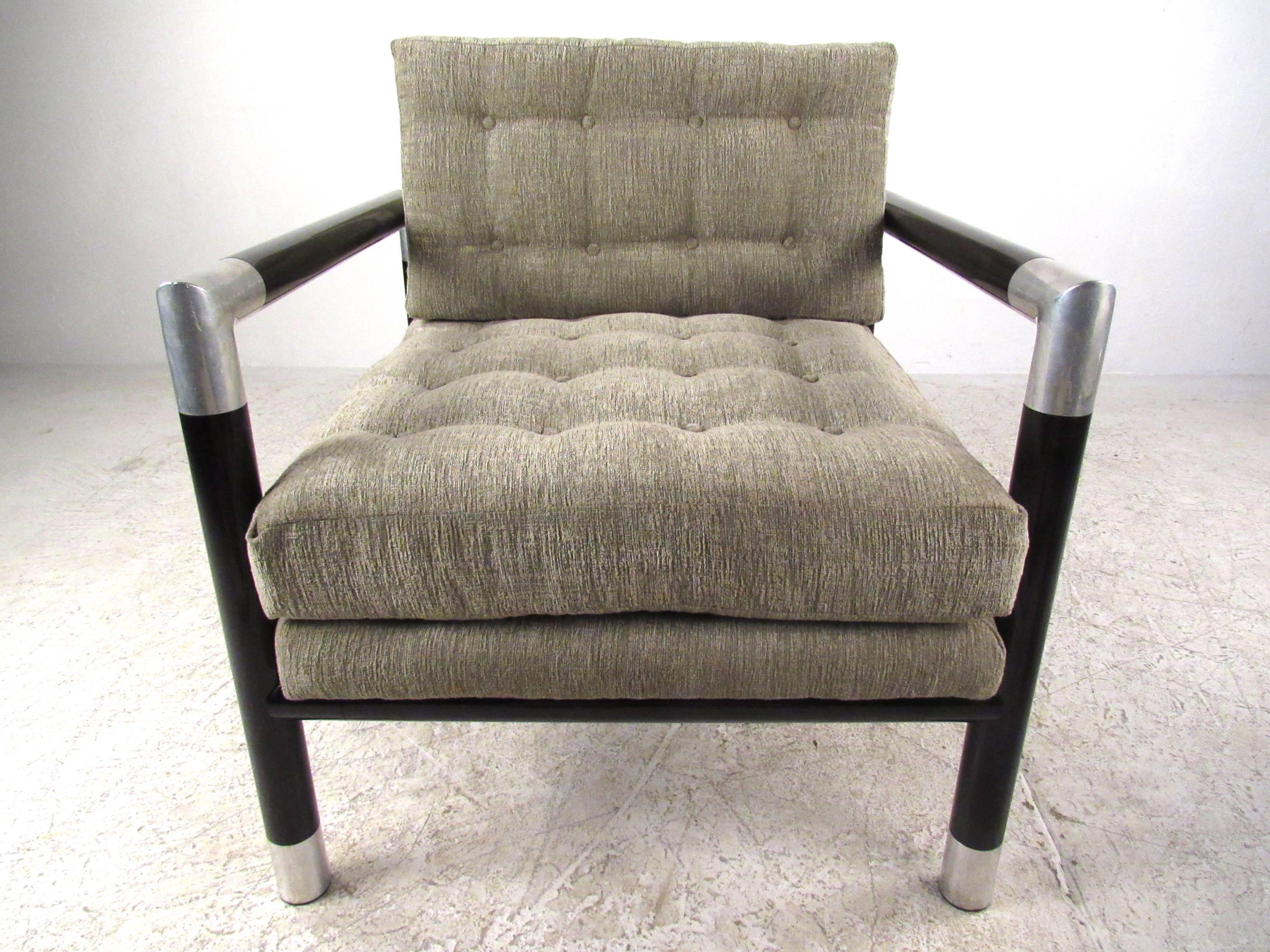 This unique matching lounge chair with ottoman features a stylish mix of brushed aluminum trim and black lacquered metal frames in Mid-Century style similar to Dunbar. Tufted upholstery adds the style of this comfortable pair. Seems like the ottoman