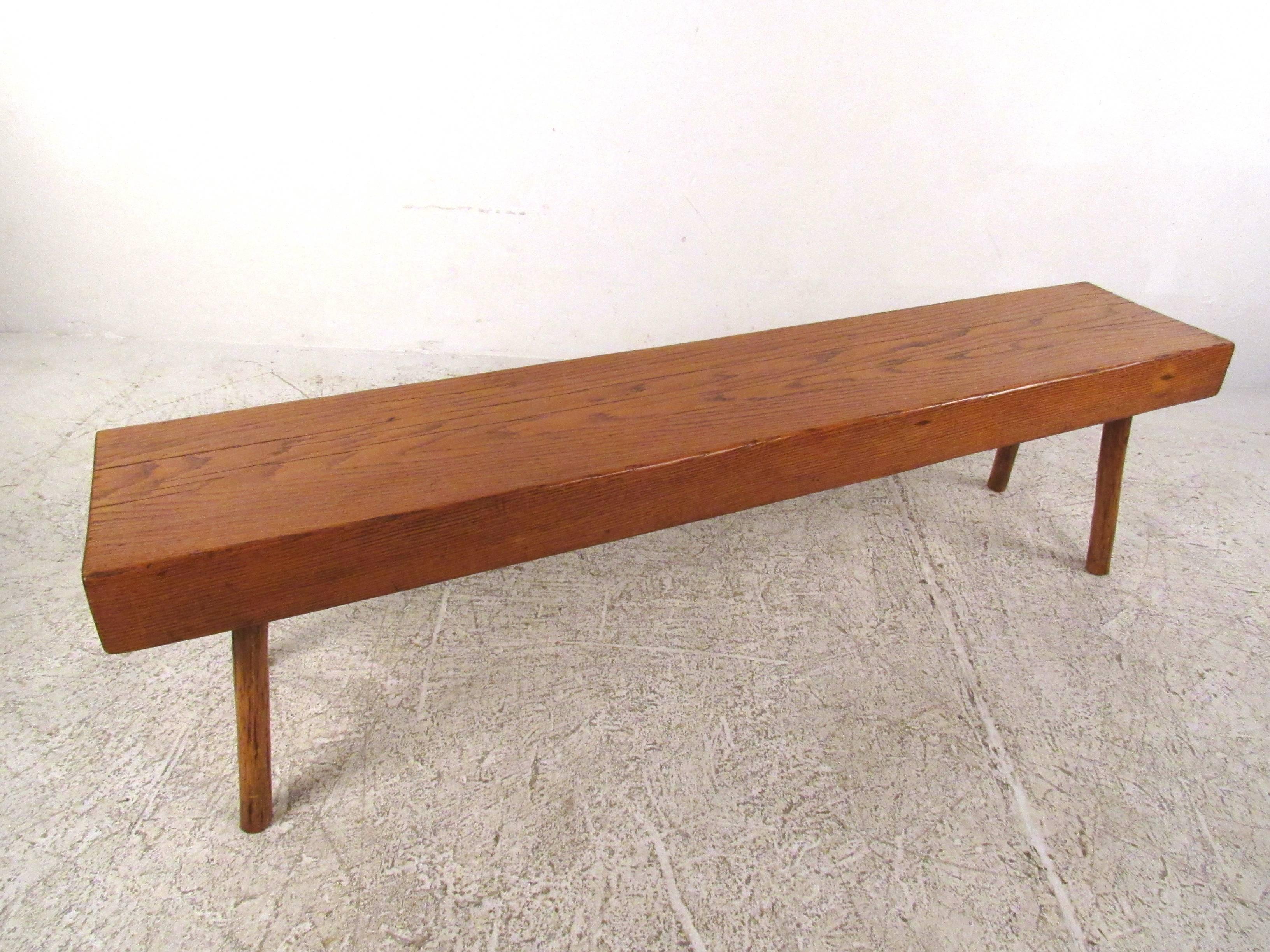 This solid oak studio made bench features quality Mid-Century construction and a versatile rustic design. Simple hand-cut oak on spindle style legs, this was a one of kind production from 1960 and makes the perfect piece for occasional seating in