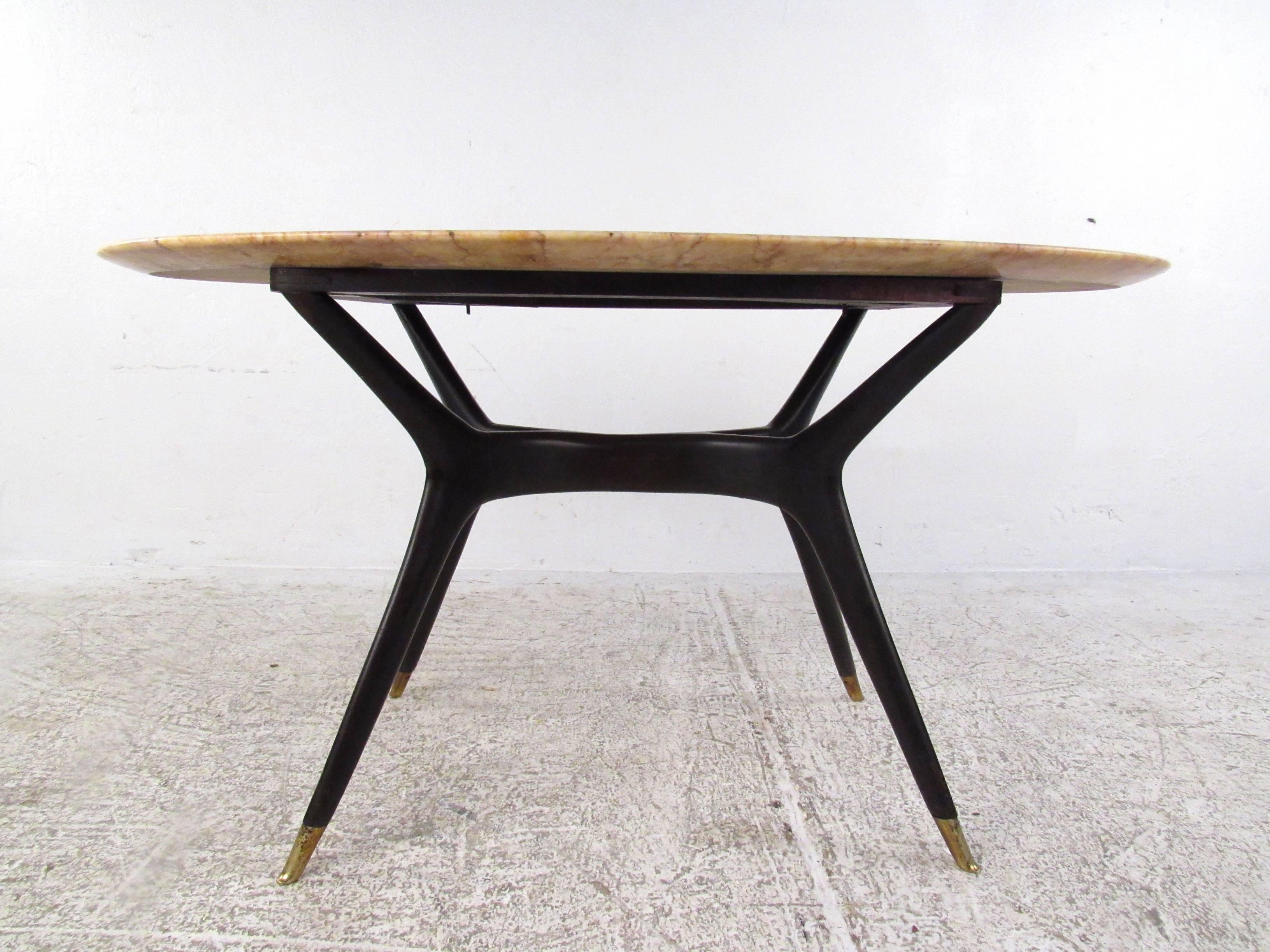 This beautiful vintage table features a unique lacquered and sculpted base in the style of Ico Parisi. Tapered legs, brass feet and unique Italian marble-top make for a beautiful centerpiece in any seating arrangement. Please confirm item location